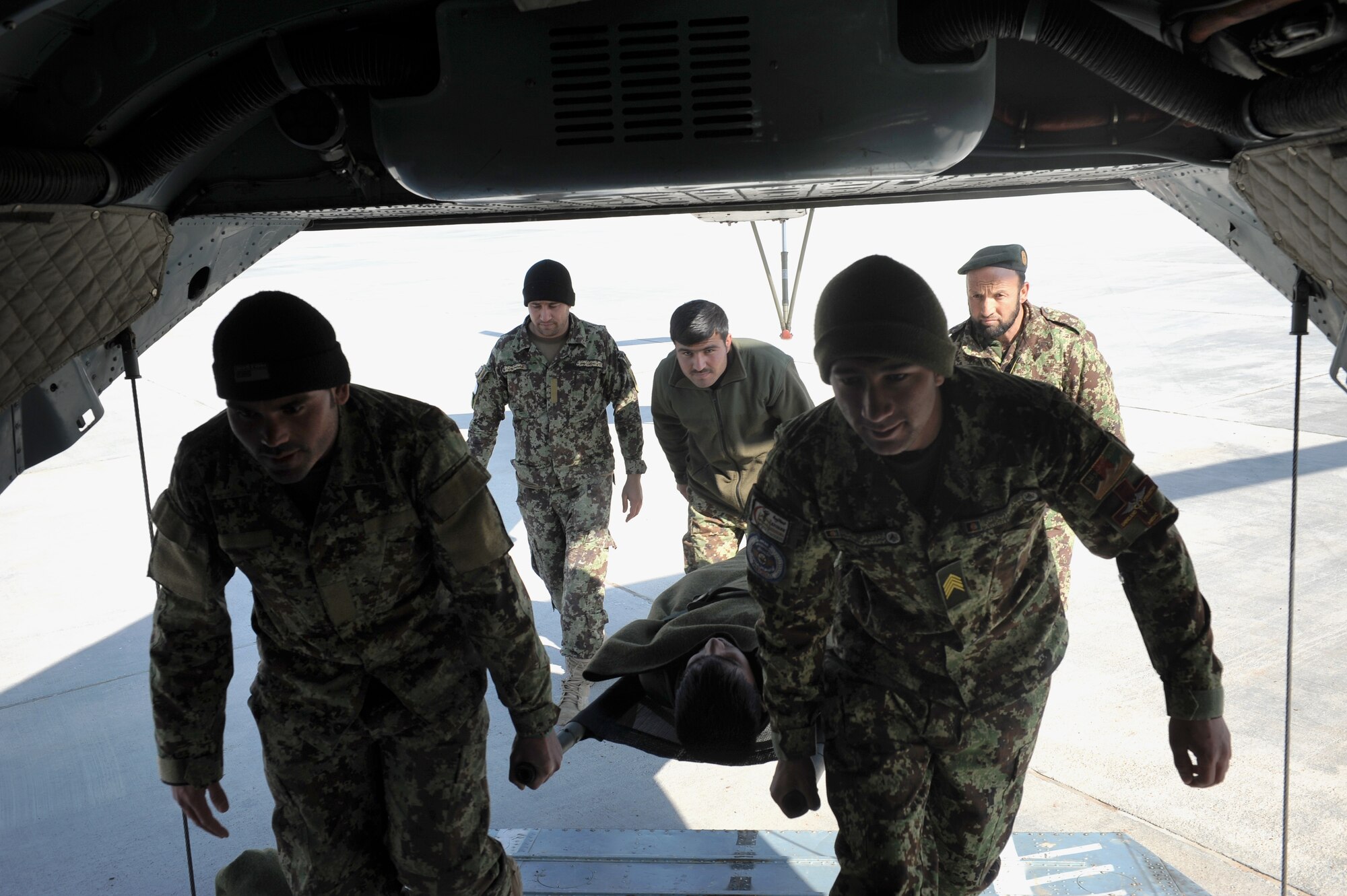 Afghan National Army personnel train on casualty evacuation, transporting a teammate onto a Mi-17 Hip, during an Afghan Air Force led training event in Herat, Afghanistan, Jan. 26, 2015. The Mi-17 is a transport helicopter capable of carrying more than three litter patients along with several mobile patients from areas inaccessible to vehicles and other aircraft. (U.S. Air Force photo/Capt. Jeff M. Nagan)
