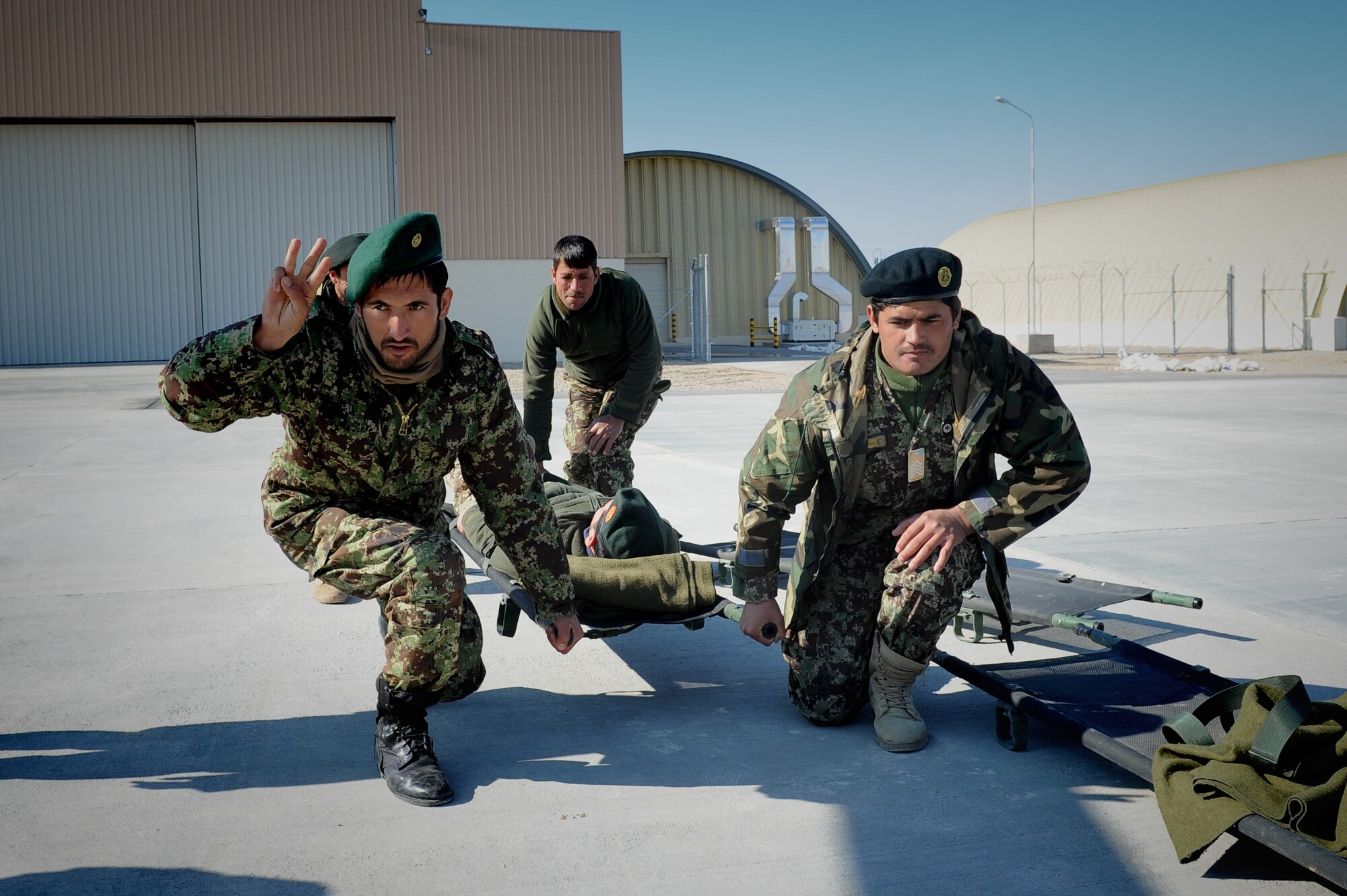 Afghan National Army soldiers practice litter carry techniques during an Afghan Air Force led training event in Herat, Afghanistan, Jan. 26, 2015. Two Afghan Air Force flight medics traveled from Kabul to Herat to teach 19 ANA soldiers the fundamentals loading casualties onto and off of the Mi-17 Hip transport helicopter and the C-208 Grand Caravan, a small, fixed wing aircraft. (U.S. Air Force photo/Capt. Jeff M. Nagan)