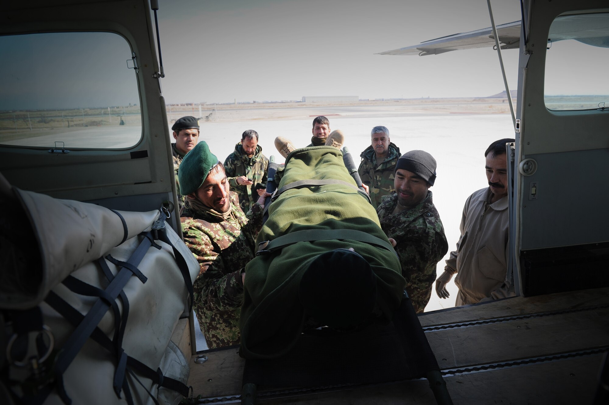 Afghan National Army soldiers load a teammate onto an C-208 Grand Caravan using casualty evacuation procedures covered in a class taught by two Afghan Air Force flight medics, Jan. 26, 2015, in Herat Afghanistan. The C-208 is a small, fixed wing aircraft that can carry one litter and several ambulatory patients and has greater transport range than a helicopter. (U.S. Air Force photo/Capt. Jeff M. Nagan)