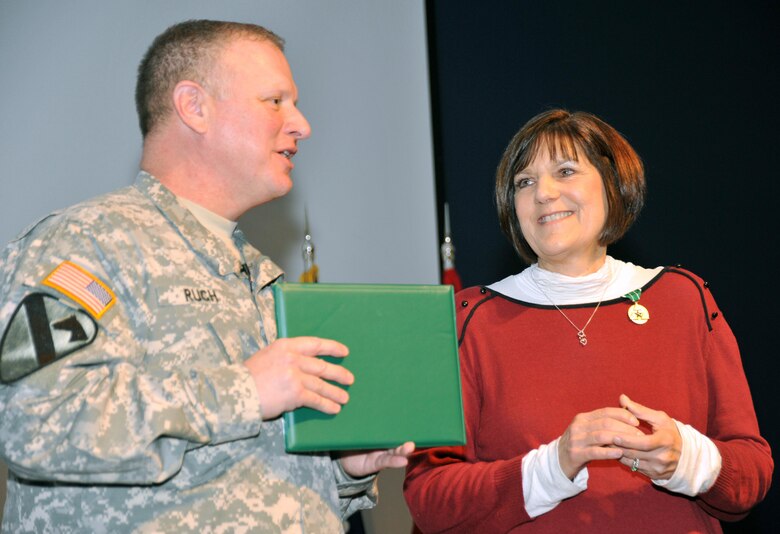 During the town hall, Col. Robert Ruch recognizes Carol Sargent with the Commander's Award for Civilian Service for her enthusiasm and hard work as the Center's 2014 CFC chairperson. Her efforts resulted in the Center surpassing its goal and raising more than $68,500 for the campaign.