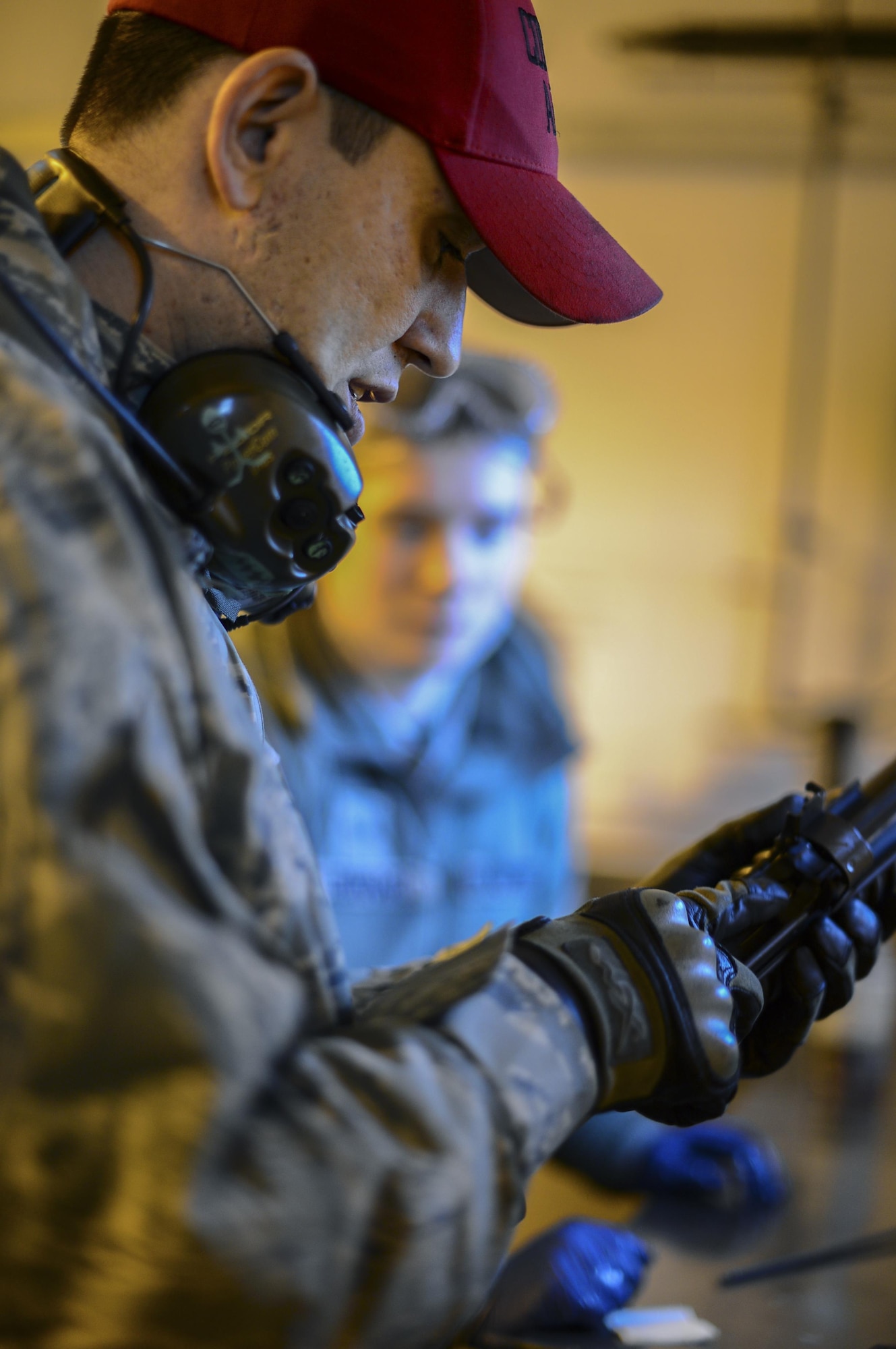 Staff Sgt. Alan Daly demonstrates disassembly, inspection and cleaning of the M203 grenade launcher Dec. 12, 2014, at Royal Air Force Feltwell, England. Daly has been a combat arms training and maintenance instructor for more than a year. Daly is a 48th Security Forces Squadron combat arms instructor. (U.S. Air Force photo/Airman 1st Class Erin R. Babis)