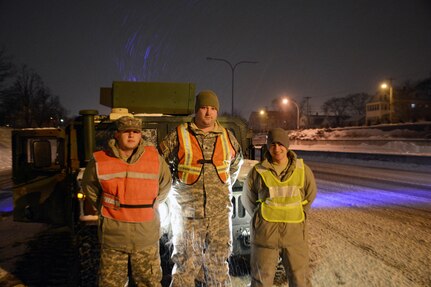 Spc. Vincent Taraborelli, right, of the 169th Military Police Company and his team provide support for the Rhode Island State Police and Rhode Island Department of Transportation on Jan. 27, 2015, as road crews remove snow from the interstate during Winter Storm Juno. Taraborelli has assisted with each storm since the Rhode Island Floods of 2010. 
