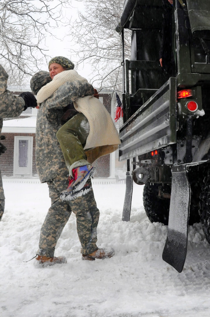 Soldiers of the Massachusetts Army National Guard augment local public servants and provide evacuation assistance to stranded residents in the coastal town of Scituate on Jan. 27, 2015.