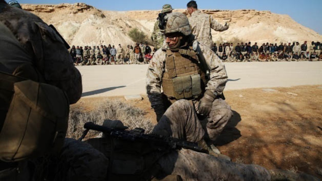 U.S. Navy Seaman Barry Sullivan, corpsman, Special Purpose Marine Air Ground Task Force-Crisis Response-Central Command, Task Force Al Asad, demonstrates to Iraqi soldiers the proper way to evaluate and move a notional casualty after an Improvised Explosive Device detonation at Al Asad Air Base, Iraq, Jan. 18, 2015. Coalition forces are facilitating training in the Build Partnership Capacity program designed to equip Iraqi army units with the training and knowledge necessary to degrade and defeat Daesh in Iraq.