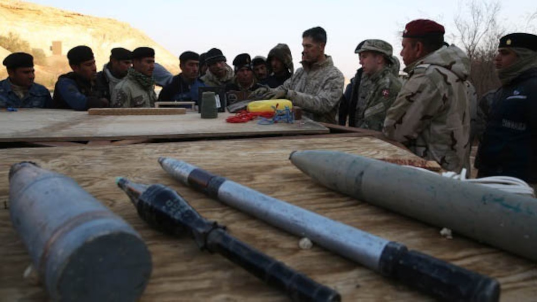 U.S. Marine Chief Warrant Officer 2 Juan Rodriguez, Explosive Ordnance Disposal Officer with Special Purpose Marine Air Ground Task Force-Crisis Response-Central Command, Task Force Al Asad, gives a Counter Improvised Explosive Device class to Iraqi soldiers at Al Asad Air Base, Iraq, Jan. 18, 2015. Rodriguez is the lead for CIED training in the Build Partnership Capacity program designed to equip Iraqi Army units with the training and knowledge necessary to degrade and defeat Daesh in Iraq.