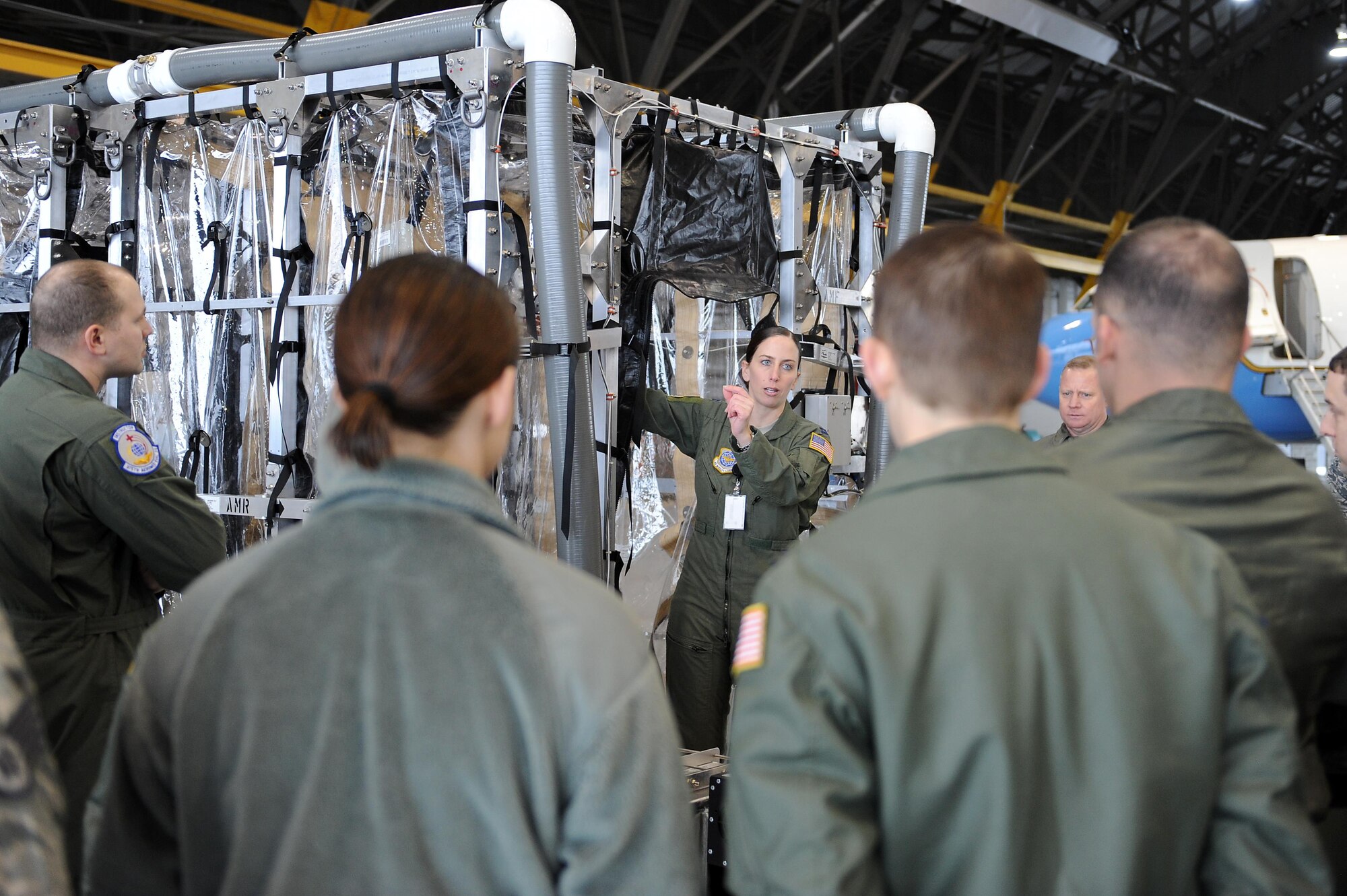 Capt. Michelle Pierson discusses the components of the Transport Isolation System (TIS) to members of the 375th and 932nd Aeromedical Evacuation Squadrons Jan. 26, 2015, at Scott Air Force Base, Illinois. Pierson was one of many Scott AFB members who has been, and will continue to advise Production Products Inc., the company who built the TIS. She is also one of the members responsible for writing all the new regulations and guidance for AMC. Pierson is an Air Mobility Command flight nurse evaluator. (U.S. Air Force photo/Staff Sgt. Jonathan Fowler)