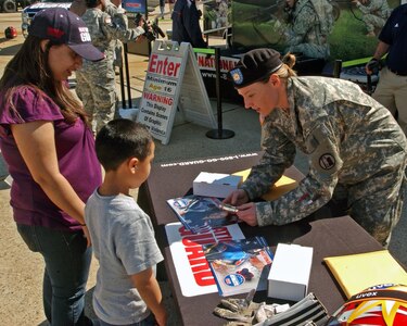 Sgt. Shauna Rohbock of the Utah National Guard shows off the silver medal she earned at the 2006 Winter Olympics to civilians during the Joint Services Open House at Andrews Joint Air Base, Md., May 15, 2010.