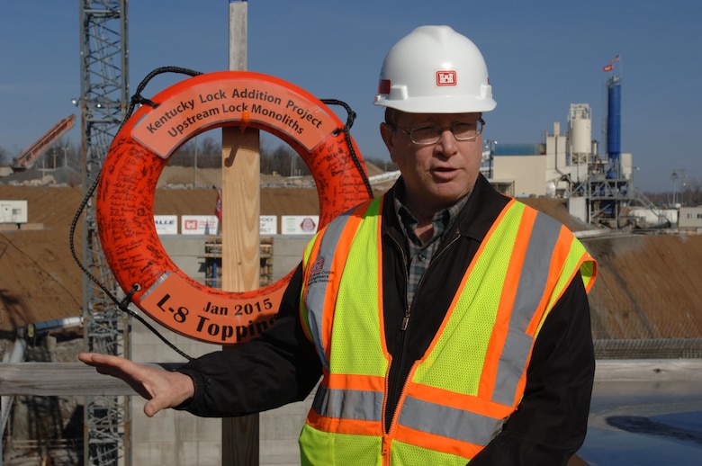 Don Getty, project manager for the Kentucky Lock Addition Project, leads an unveiling ceremony of the first completed massive monolith from a viewpoint over the construction site in Grand Rivers, Ky., Jan. 28, 2015. The contractor, Thalle Construction, participated in the event commemorating this first important milestone.