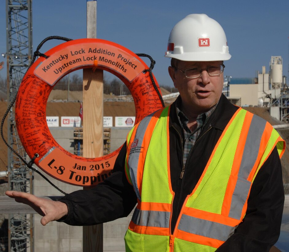Don Getty, project manager for the Kentucky Lock Addition Project, leads an unveiling ceremony of the first completed massive monolith from a viewpoint over the construction site in Grand Rivers, Ky., Jan. 28, 2015. The contractor, Thalle Construction, participated in the event commemorating this first important milestone.