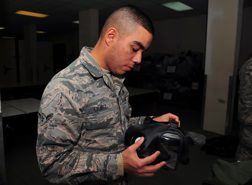 Airman John Chaves, 51st Civil Engineer Squadron electrical systems journeyman, inspects a gas mask to ensure it works properly at the 51st Logistic Readiness Squadron individual protective equipment building Jan. 27, 2015, at Osan Air Base, Republic of Korea. The mission of the IPE unit is to ensure that all essential personnel in-processing at Osan receives their chemical gear. (U.S. Air Force photo by Senior Airman David Owsianka)