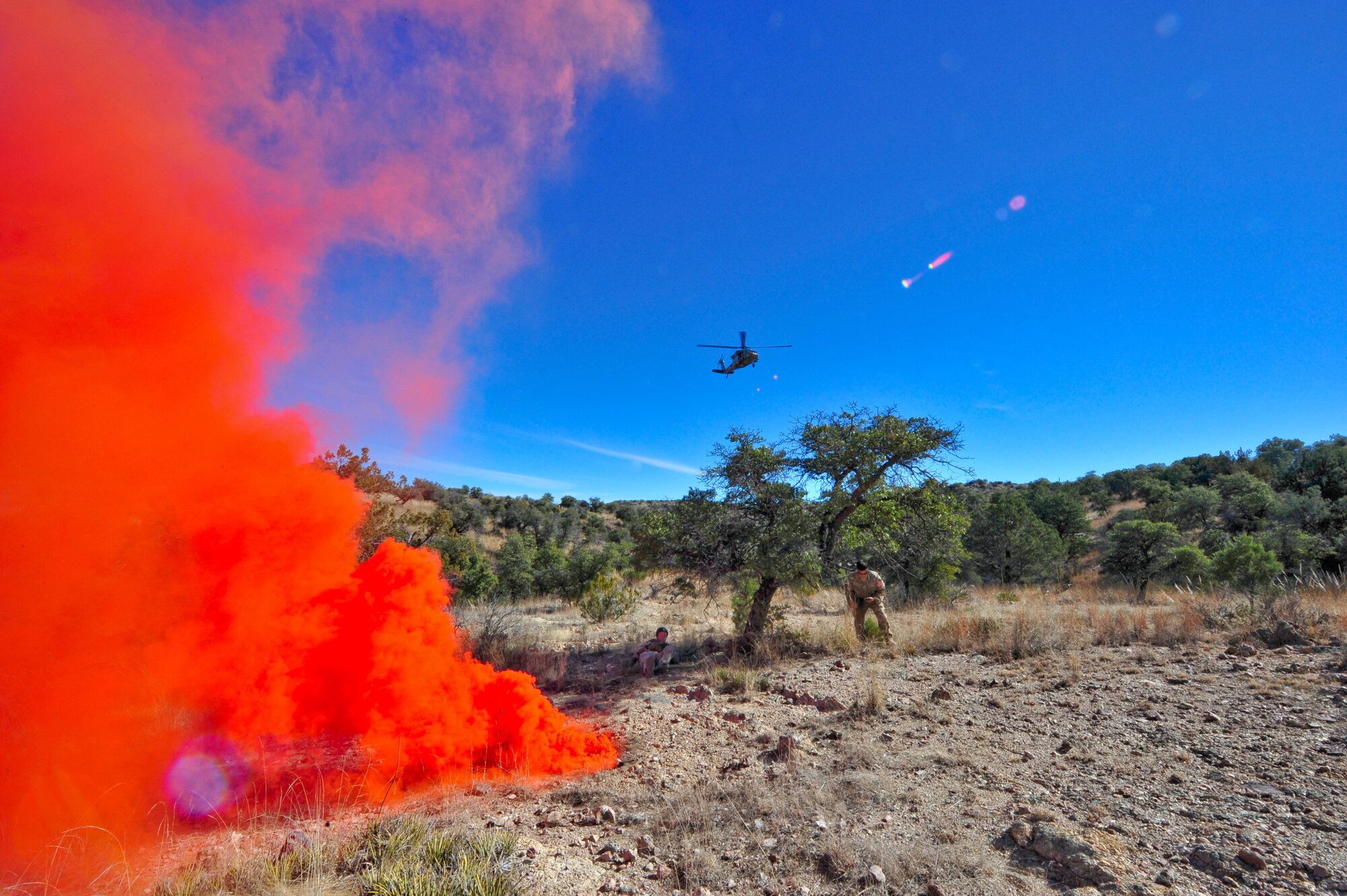 An Arizona Army National Guard UH-60A Black Hawk helicopter from Detachment 1, C Company, 5-159th Air Ambulance, based out of Phoenix, approaches simulated downed pilots after spotting smoke from simulated downed pilots during joint training at a southern Arizona military training range, Jan. 20, 2015.  The joint training consisted of A-10C Thunderbolt IIs from the 354th Fighter Squadron, based out of Davis-Monthan Air Force Base, and the UH-60A Black Hawk helicopter from Detachment 1, C Company, 5-159th Air Ambulance, based out of Phoenix, conducting close air support and combat search and rescue exercises.  (U.S. Air Force Photo by Airman 1st Class Chris Massey/Released)