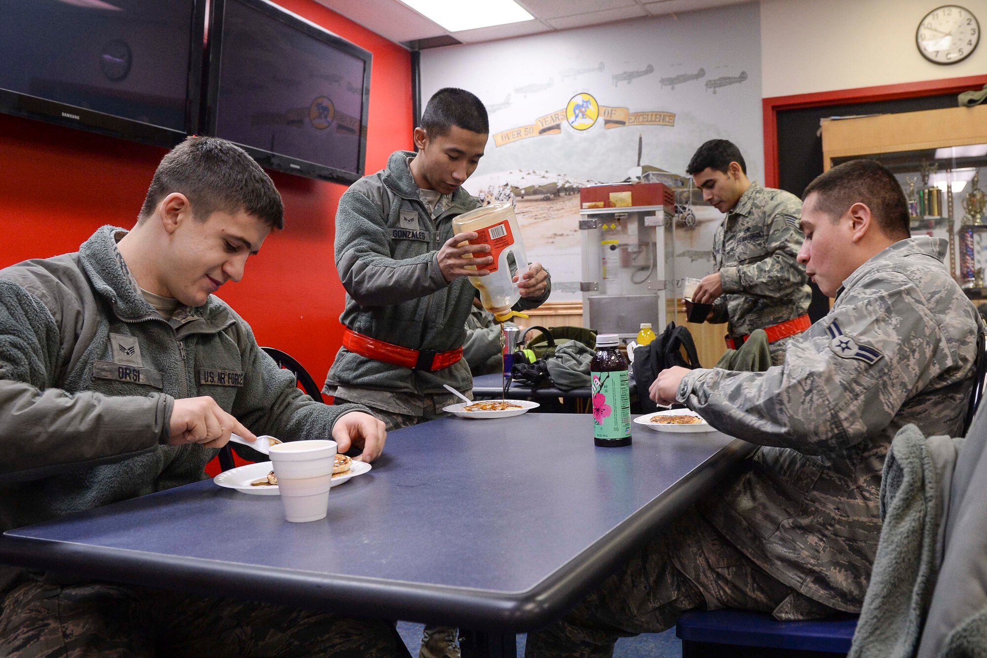 U.S. Air Force aircraft maintenance Airmen assigned to the 354th Aircraft Maintenance Squadron receive a pancake breakfast at the 18th Aircraft Maintenance Unit (AMU) hangars on Eielson Air Force Base, Alaska, Jan. 15, 2014. Leadership at 18th AMU helped with their Airmen's morale by cooking breakfast for maintainers while they worked to launch numerous aircraft simultaneously for a large-scale exercise. (U.S. Air Force Photo by Senior Airman Peter Reft/Released)