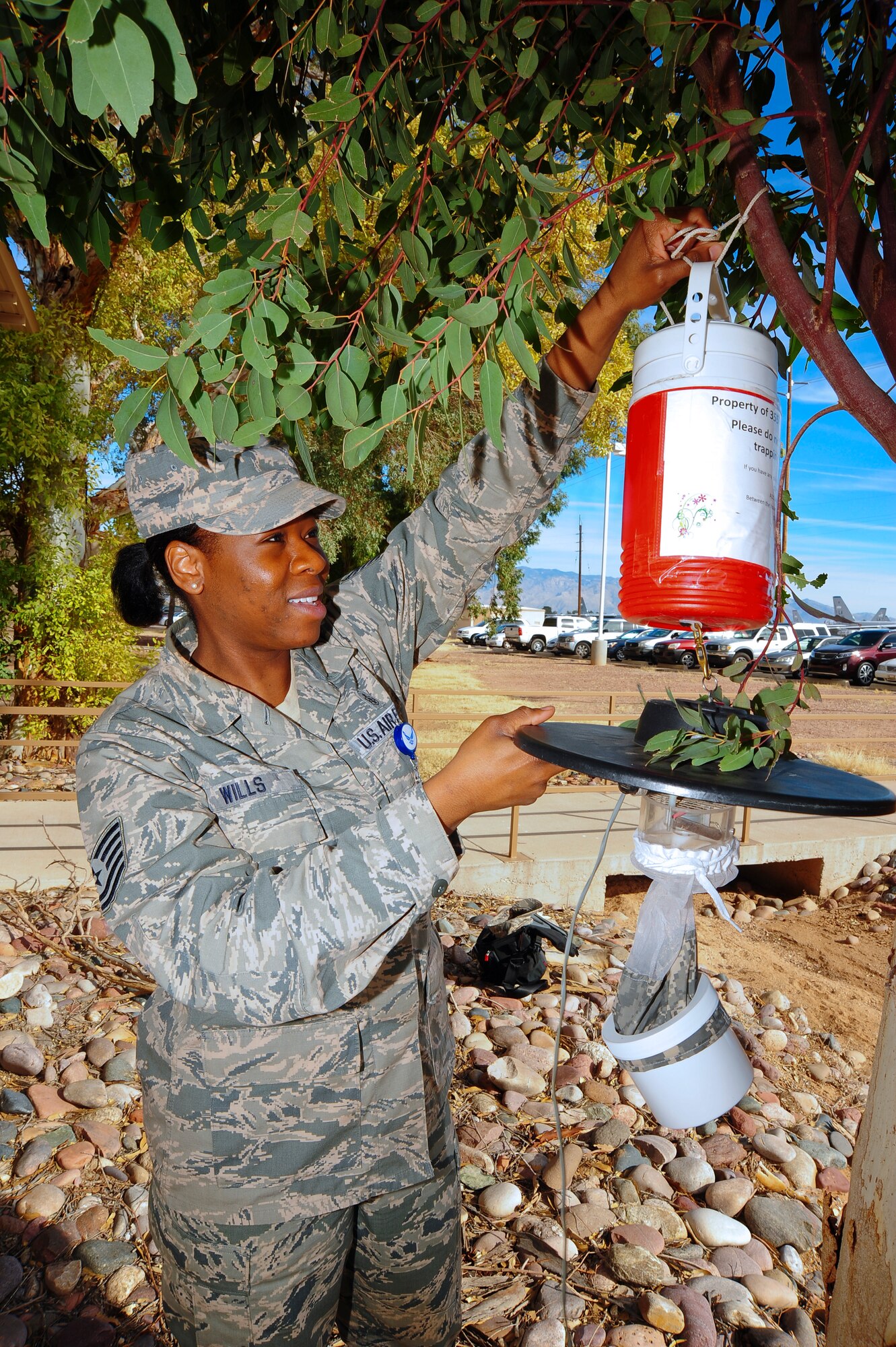 U.S. Air Force Tech. Sgt. Patrice Wills, 355th Aerospace Medicine Squadron community health element chief, sets up a mosquito trap for infectious disease testing at Davis-Monthan Air Force Base, Ariz., Jan. 28, 2015. The Biomedical Sciences Corps encompasses 15 Air Force Specialty Codes, with 10 of those AFSC’s practiced at D-M. The 355th Medical Group is celebrating Biomedical Sciences Corps Appreciation week in conjunction with the Corps’ 50th anniversary. (U.S. Air Force photo by Staff Sgt. Angela Ruiz)