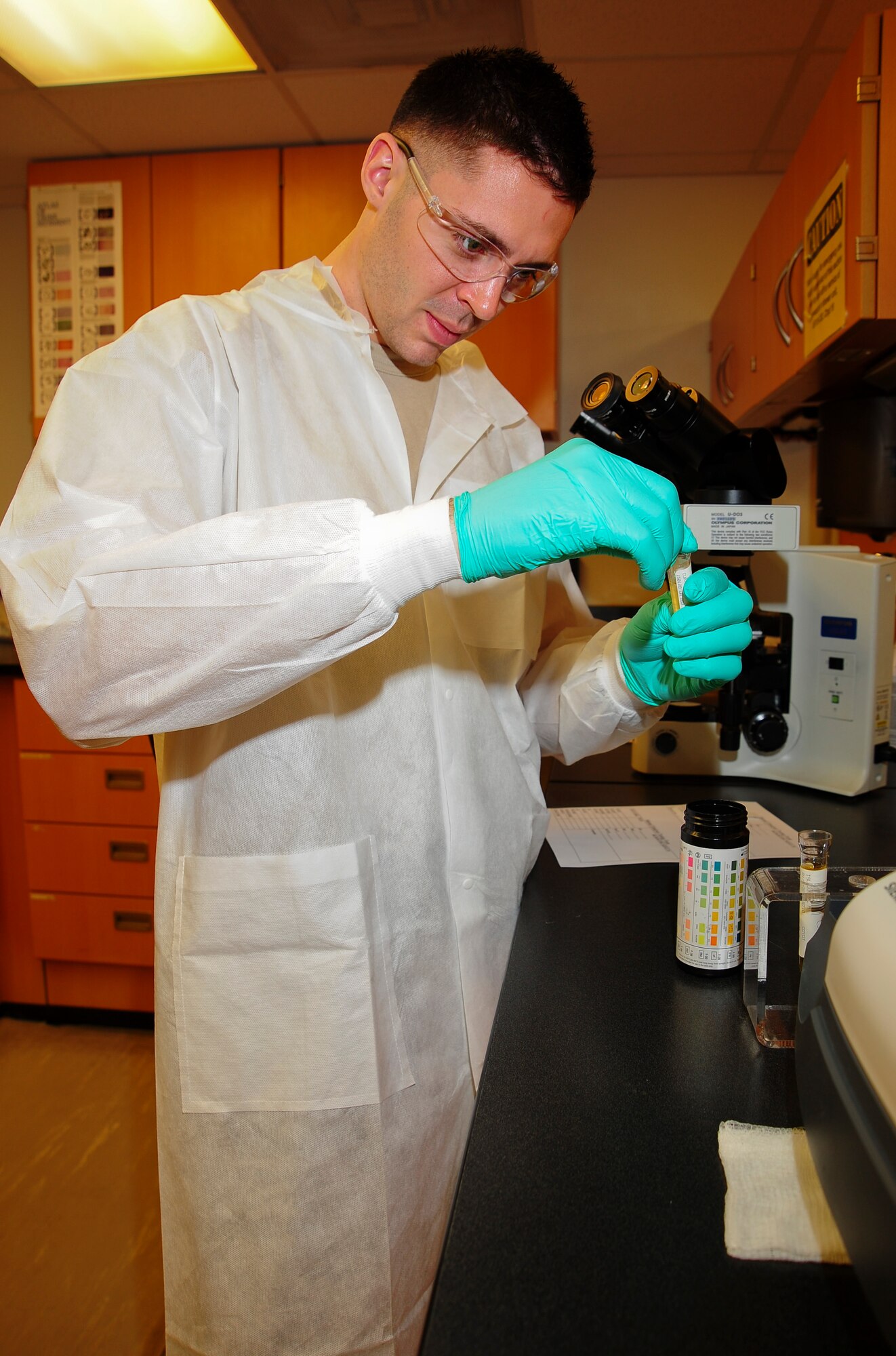 U.S. Air Force Airman 1st Class John Corbett, 355th Medical Support Squadron medical laboratory technician, tests a urine sample at Davis-Monthan Air Force Base, Ariz., Jan. 28, 2015. The 355th Medical Group is celebrating the 50th anniversary of the Biomedical Sciences Corps this week.  (U.S. Air Force photo by Staff Sgt. Angela Ruiz)
