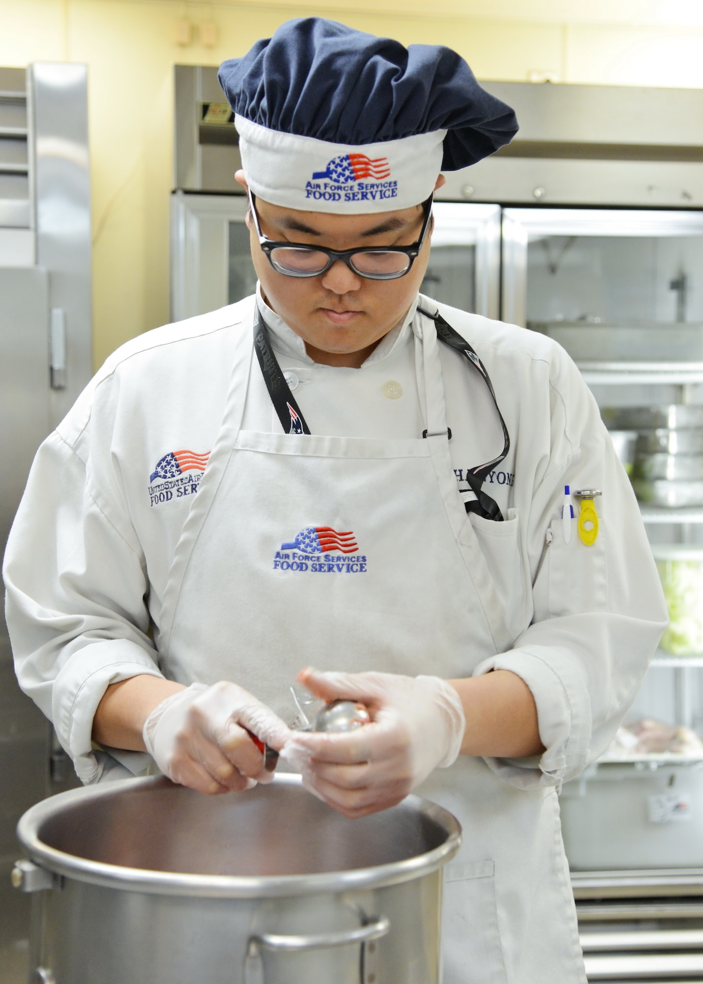 Changyoung Choi prepares a meal at Kirtland’s military dining facility, the Thunderbird Inn.The facility serves 600 or more meals a day. (Photo by Jamie Burnett)