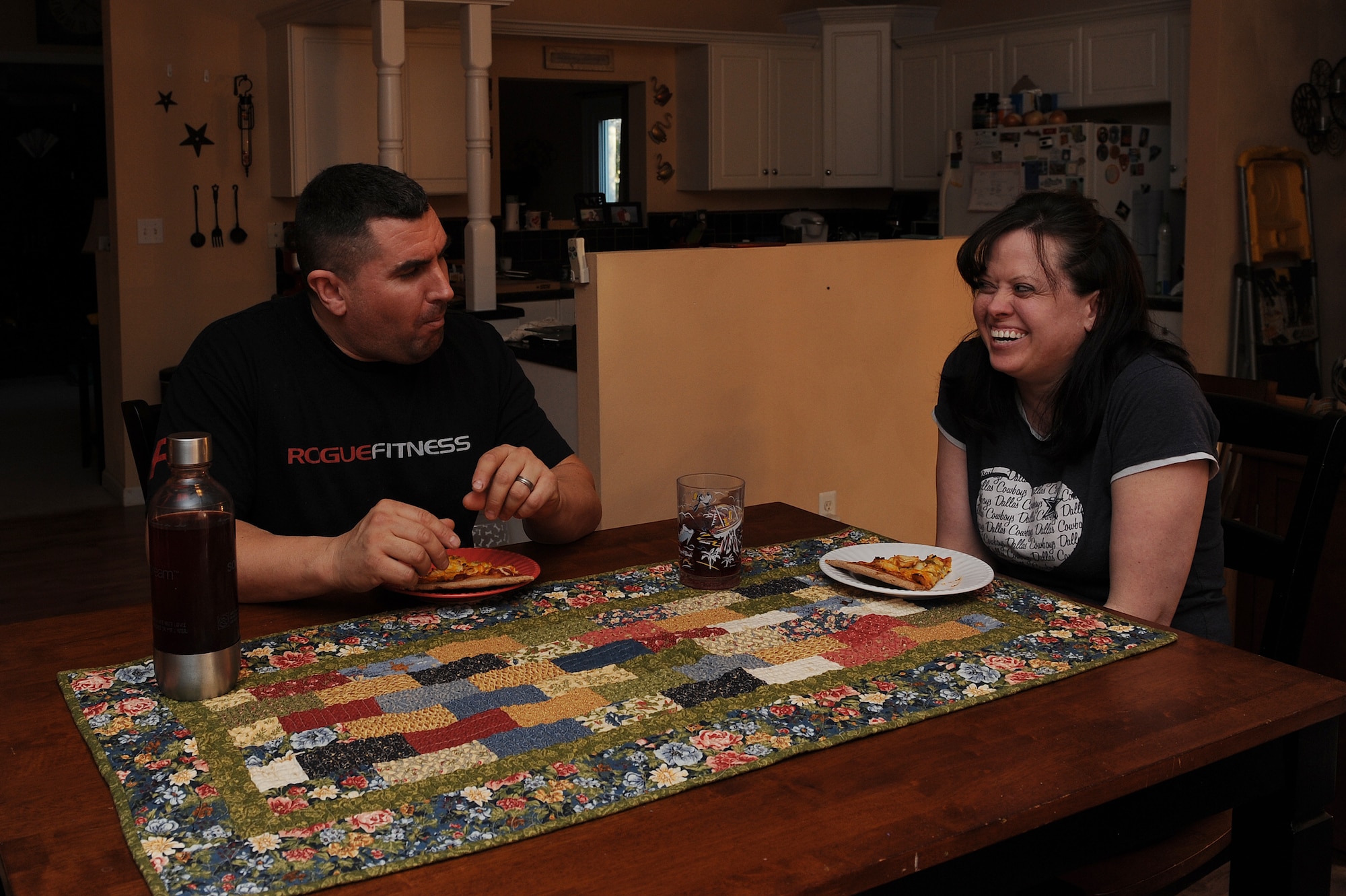 Master Sgt. Scott Stuehrenberg and his wife, enjoy the wheat pizza they made from scratch at home.  Since they have started counting calories and monitoring their portions, Scott and Lisa have lost a total of 90 pounds.  Stuehrenberg is a 618th Air and Space Operations global operations manager.  (U.S. Air Force photo by Staff Sgt. Maria Bowman)