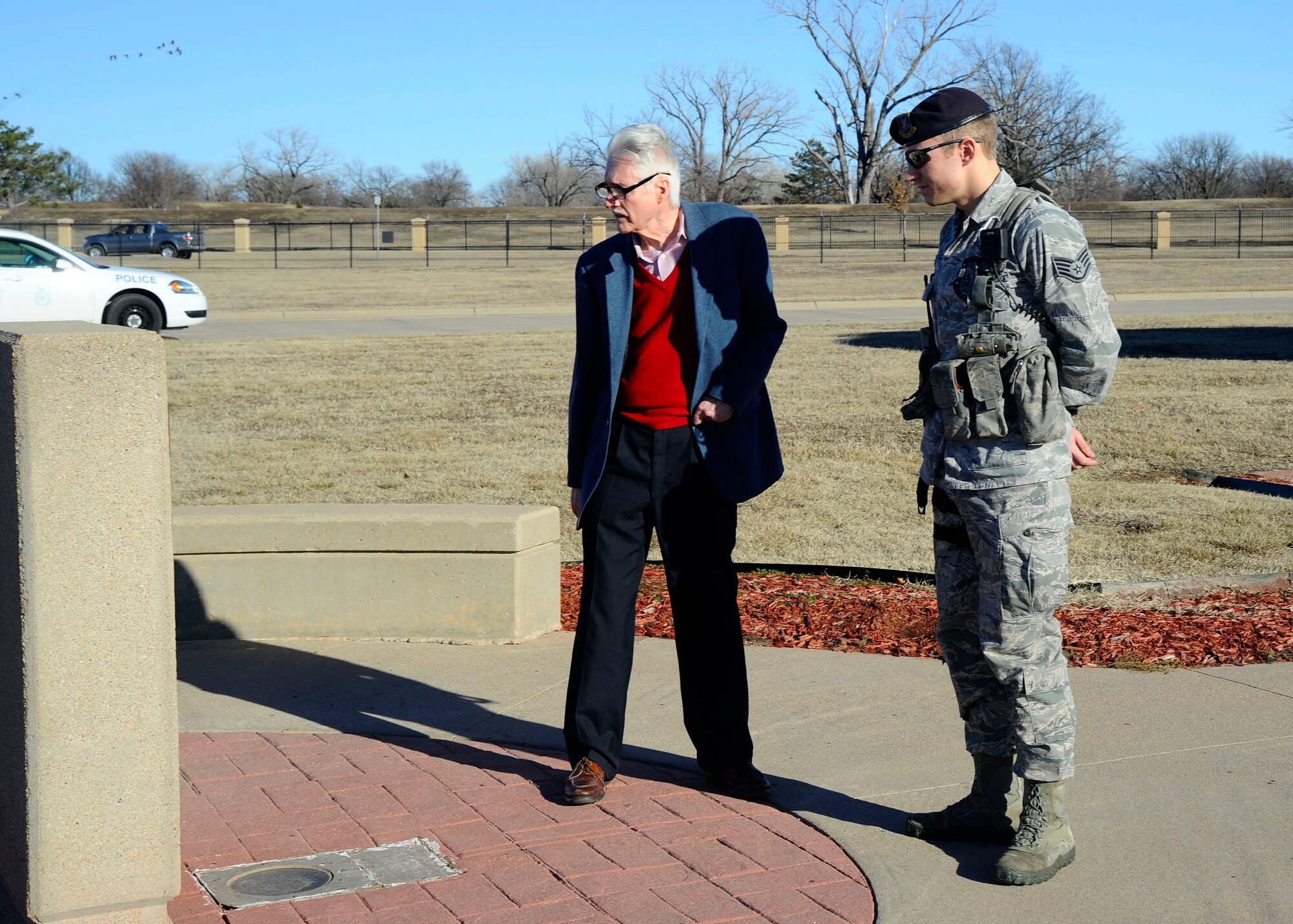 Stephen Carlton and Staff Sgt. Sean Rousseau, 22nd Security Forces Squadron patrolman, visit a memorial, Jan. 17, 2014, at McConnell Air Force Base, Kan. Carlton was stationed at McConnell in the 1960s and was able to tour the base and meet with current security forces Airmen to see how the Air Force has changed in the last 50 years. (U.S. Air Force photo/Senior Airman Victor J. Caputo)