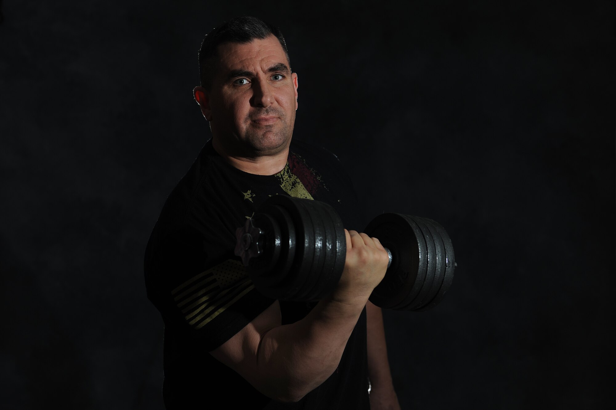 Master Sgt. Scott Stuehrenberg enjoys lifting weights during his workout sessions.  In addition to going to the gym, Stuehrenberg maintains his weight by monitoring his calorie intake.  Stuehrenberg is a 618th Air and Space Operations global operations manager.  (U.S. Air Force photo by Staff Sgt. Maria Bowman)