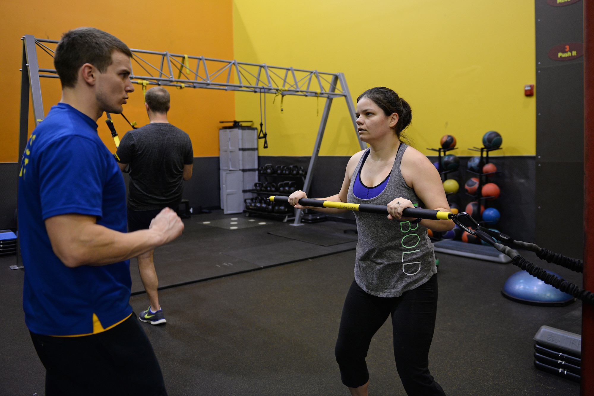 Jessi McNulty, 26, performs a tension exercise, while Nate Myers, her personal trainer instructs her on proper form at her gym, O’Fallon, Ill., Jan. 22, 2015. This Air Force spouse has been hitting this gym for nearly two years, during which time she has lost 90 pounds despite having temporal lobe epilepsy. Generally her workouts are total-body-oriented and her and her personal trainer monitors her heart rate to mitigate her seizures, which are exercise-induced. (U.S. Air Force photo by Airman 1st Class Erica Crossen)
