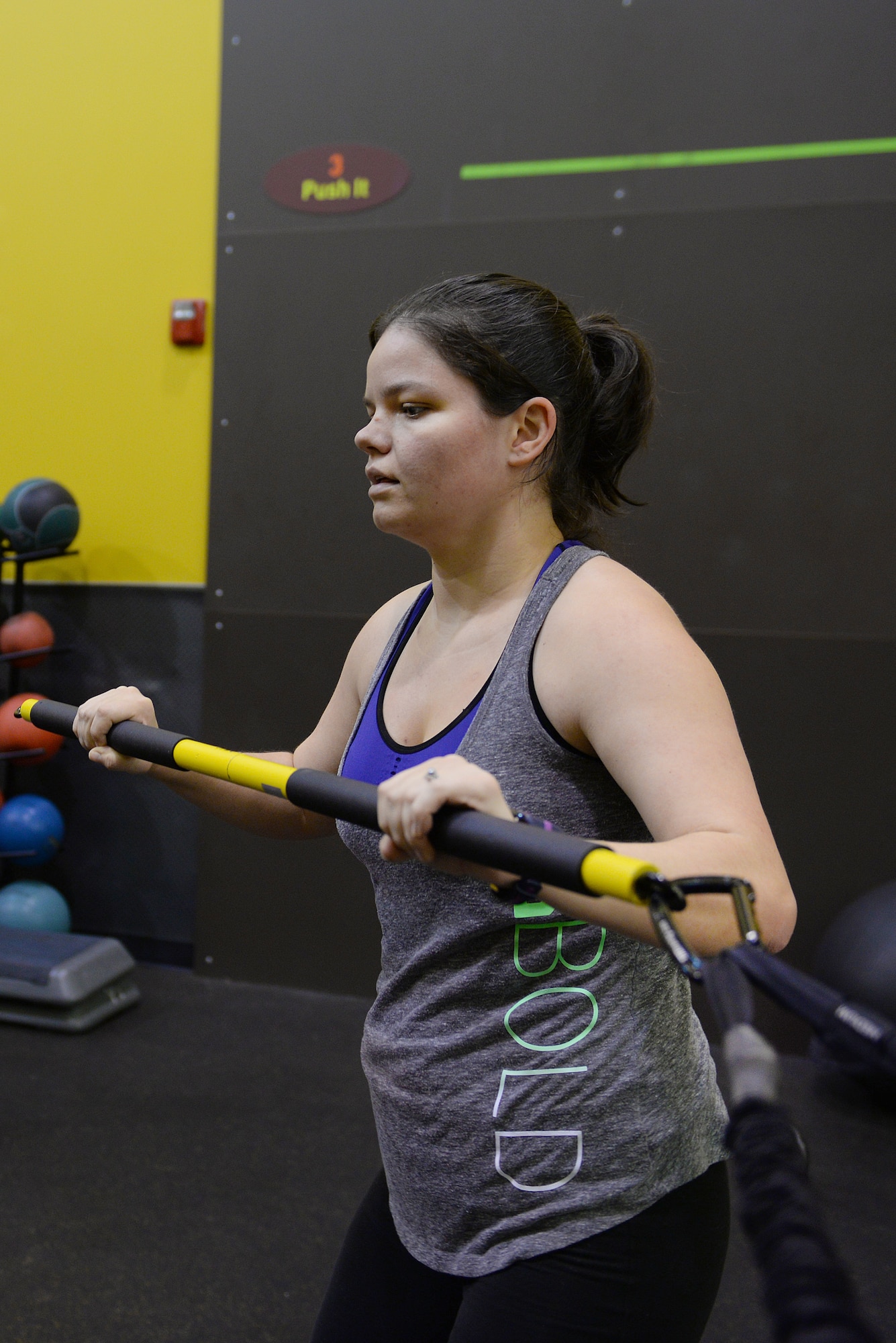 Jessi McNulty, 26, performs a tension exercise at her gym, O’Fallon, Ill., Jan. 22, 2015. This Air Force spouse has been hitting this gym for nearly two years, during which time she has lost 90 pounds despite having temporal lobe epilepsy. Generally her workouts are total-body-oriented and her and her personal trainer monitors her heart rate to mitigate her seizures, which are exercise-induced. (U.S. Air Force photo by Airman 1st Class Erica Crossen)