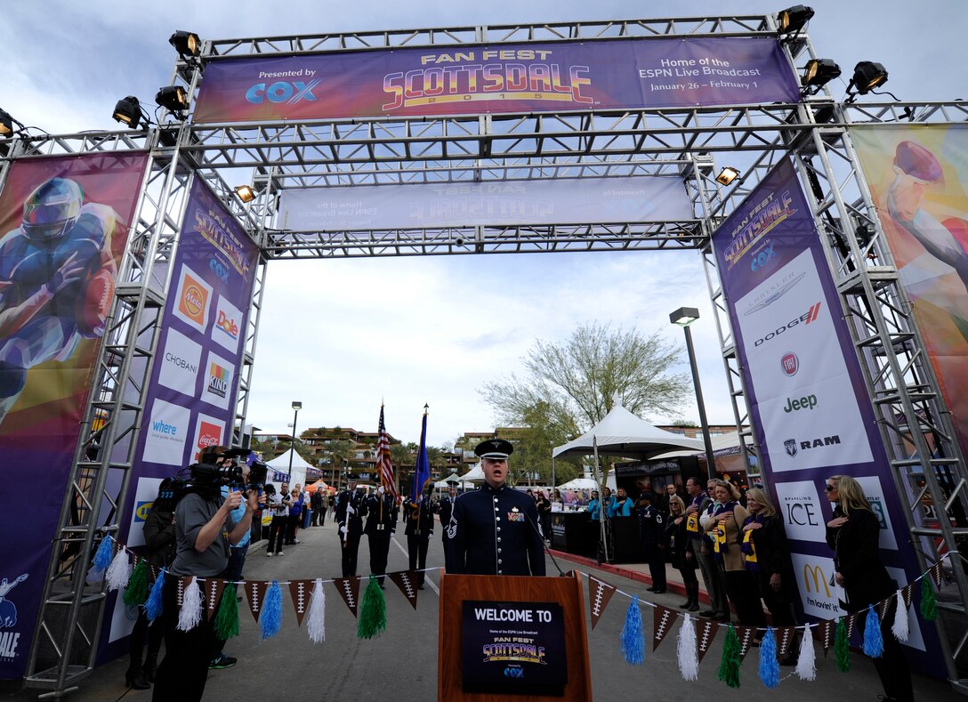 Senior Master Sgt. Ryan L. Carson, U.S. Air Force Band Max Impact vocalist, sings the National Anthem during a ribbon cutting ceremony at Fan Fest in Scottsdale, Ariz., Jan. 26, 2015. The band’s mission is to honor those who have served, inspire American citizens to heighten patriotism and services, and positively impact the global community on behalf of the USAF and United States of America. (U.S. Air Force photo by Senior Airman Nesha Humes)