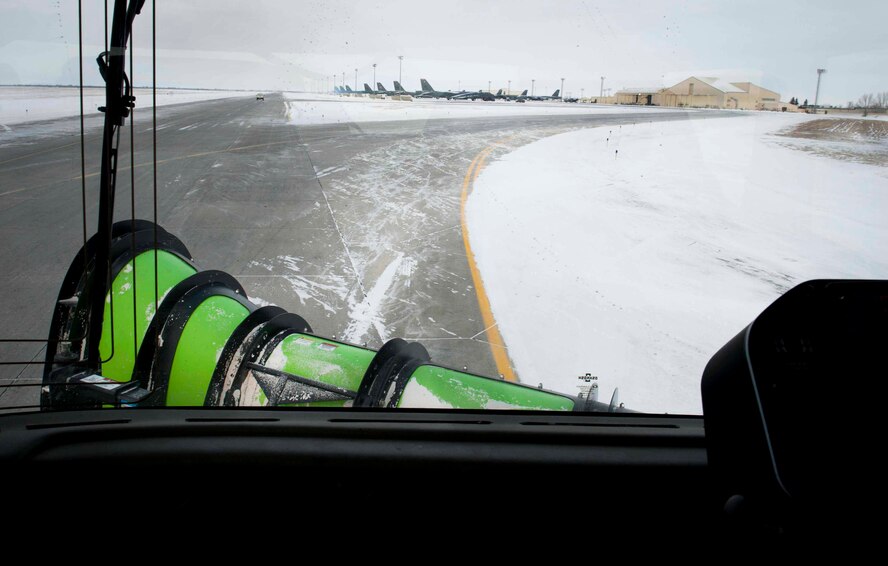 A snow plow removes snow from the flightline on Minot Air Force Base, N.D., Jan. 21, 2015. The plows are used to move large amounts of snow and clear high traffic areas. (U.S. Air Force photo/Airman 1st Class Sahara L. Fales) 