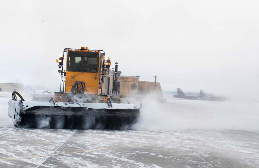 Snow brooms remove snow from the flight line on Minot Air Force Base, N.D., Jan. 21, 2015. They are responsible for clearing high traffic areas such as the flightline and helicopter pad to maintain mission readiness even during cold weather. (U.S. Air Force photo/Airman 1st Class Sahara L. Fales) 