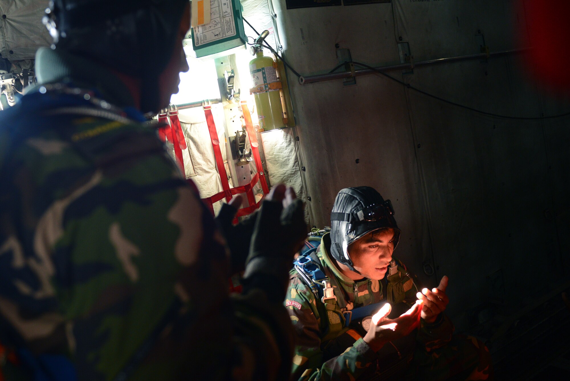 Bangladeshi paratroopers perform a traditional prayer aboard a U.S. Air Force C-130H aircraft during a personnel drop mission at Exercise COPE SOUTH near Sylhet, Bangladesh, Jan. 24, 2015. COPE SOUTH is a Pacific Air Forces-sponsored, bilateral tactical airlift exercise conducted in Bangladesh, with a focus on cooperative flight operations, day and night low-level navigation, tactical airdrop, and air-land missions as well as subject-matter expert exchanges in the fields of operations, maintenance and rigging disciplines. (U.S. Air Force photo by 1st Lt. Jake Bailey/Released)