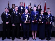 The 628th Air Base Wing held its 2014 Annual Awards ceremony Jan. 23, 2015 at the Charleston Club on Joint Base Charleston, S.C. Winners are (from back left)  Logistics Specialist 3rd Class Delmetrius Blanding, Naval Support Activity, Blue Jacket of the Year; Capt. Joshua Van Wyngaarden, 628th Medical Operations Squadron, Company Grade Officer of the Year; Catherine Hallett, 628th MDOS, Civilian Category II of the Year; Ms. Anna Urrutia, 628th Contracting Squadron, Civilian Category III of the Year; (from front left) Master at Arms 2nd Class Brian Cobb, NSA, Junior Sailor of the Year; Master at Arms 1st Class Mark VanWyck, NSA, Senior Sailor of the Year; Master Sgt. Eric Rainer, 628th Medical Group, First Sergeant of the Year; Senior Airman Hannah Leonard, 628th Aerospace Medicine Squadron, Airman of the Year; Master Sgt. Kari Boyles, 628th AMDS, SNCO of the Year and Senior Airman Erin Winkler, 437th Aircraft Maintenance Squadron, Honor Guard Member of the Year. Not pictured is Phillip Hull, 628th Security Forces Squadron, Civilian Category I and Tech. Sgt. Toriano Banks, 628th Comptroller Squadron, NCO of the year. (U.S. Air Force photo/Airman 1st Class Clayton Cupit)