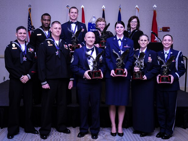 The 628th Air Base Wing held its 2014 Annual Awards ceremony Jan. 23, 2015 at the Charleston Club on Joint Base Charleston, S.C. Winners are (from back left)  Logistics Specialist 3rd Class Delmetrius Blanding, Naval Support Activity, Blue Jacket of the Year; Capt. Joshua Van Wyngaarden, 628th Medical Operations Squadron, Company Grade Officer of the Year; Catherine Hallett, 628th MDOS, Civilian Category II of the Year; Ms. Anna Urrutia, 628th Contracting Squadron, Civilian Category III of the Year; (from front left) Master at Arms 2nd Class Brian Cobb, NSA, Junior Sailor of the Year; Master at Arms 1st Class Mark VanWyck, NSA, Senior Sailor of the Year; Master Sgt. Eric Rainer, 628th Medical Group, First Sergeant of the Year; Senior Airman Hannah Leonard, 628th Aerospace Medicine Squadron, Airman of the Year; Master Sgt. Kari Boyles, 628th AMDS, SNCO of the Year and Senior Airman Erin Winkler, 437th Aircraft Maintenance Squadron, Honor Guard Member of the Year. Not pictured is Phillip Hull, 628th Security Forces Squadron, Civilian Category I and Tech. Sgt. Toriano Banks, 628th Comptroller Squadron, NCO of the year. (U.S. Air Force photo/Airman 1st Class Clayton Cupit)