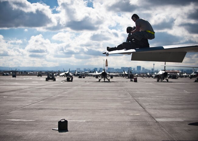 Two maintainers assigned to the 748th Aircraft Maintenance Squadron, Royal Air Force Lakenheath, England, work on the wing of an F-15 Eagle during Red Flag 15-1 at Nellis Air Force Base, Nev., Jan. 27, 2015. Maintainers are responsible for overseeing the day-to-day maintenance of aircraft, including diagnosing malfunctions and replacing components, and conducting various inspections to ensure the aircraft is functioning properly. (U.S. Air Force photo by Staff Sgt. Siuta B. Ika)