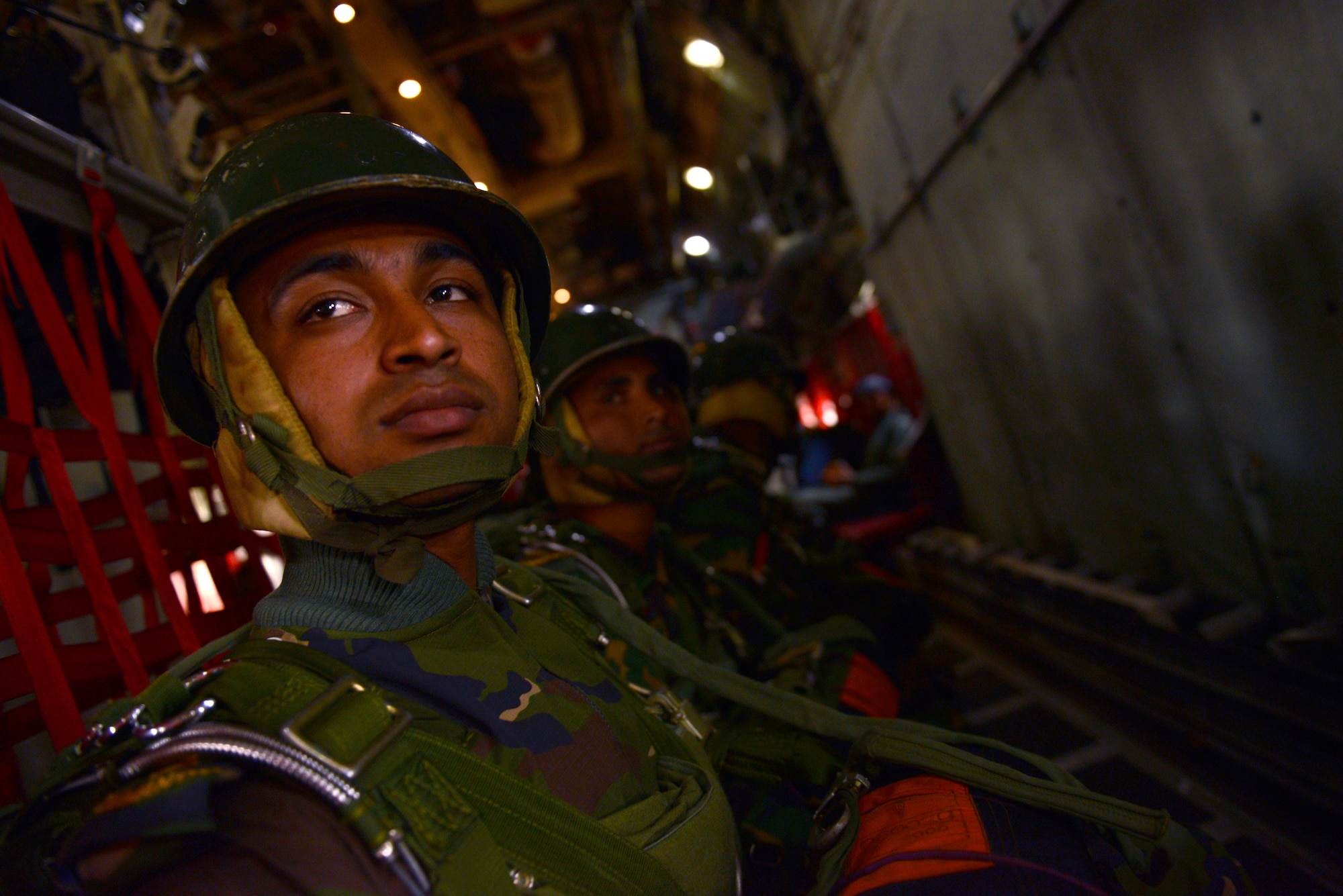 A Bangladeshi paratrooper prepares to jump from a U.S. Air Force C-130H aircraft during Exercise COPE SOUTH near Sylhet, Bangladesh, Jan. 25, 2015. COPE SOUTH is a Pacific Air Forces-sponsored, bilateral tactical airlift exercise conducted in Bangladesh, with a focus on cooperative flight operations, day and night low-level navigation, tactical airdrop, and air-land missions as well as subject-matter expert exchanges in the fields of operations, maintenance and rigging disciplines. (U.S. Air Force photo by 1st Lt. Jake Bailey/Released)