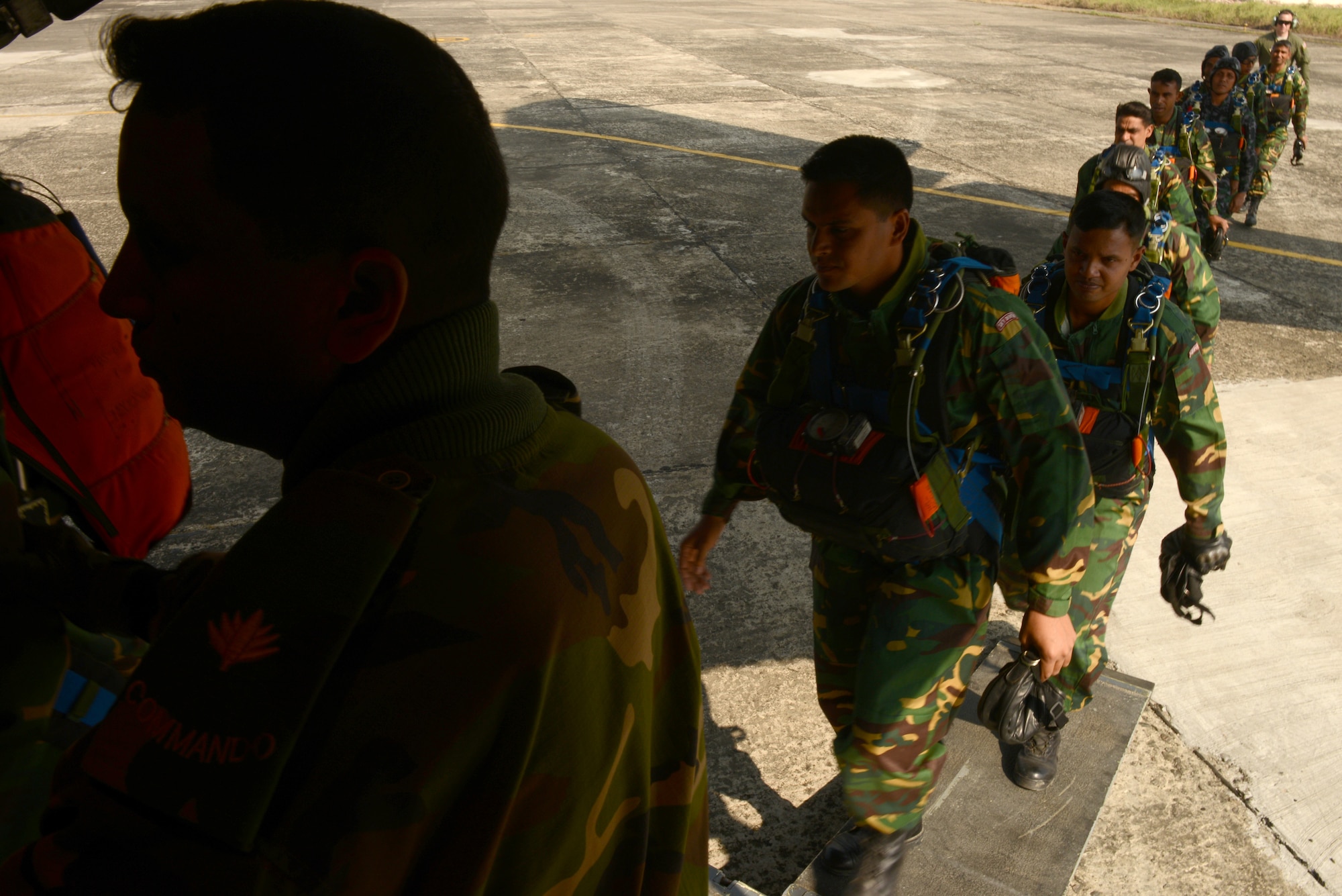 Bangladeshi commandos board a U.S. Air Force C-130H aircraft at Sylhet International Airport, Bangladesh, before conducting a personnel airdrop mission during Exercise COPE SOUTH, Jan. 25, 2015. COPE SOUTH helps cultivate common bonds, foster goodwill, and improve readiness and compatibility between members of the Bangladesh and U.S. Air Forces. (U.S. Air Force photo by 1st Lt. Jake Bailey/Released)