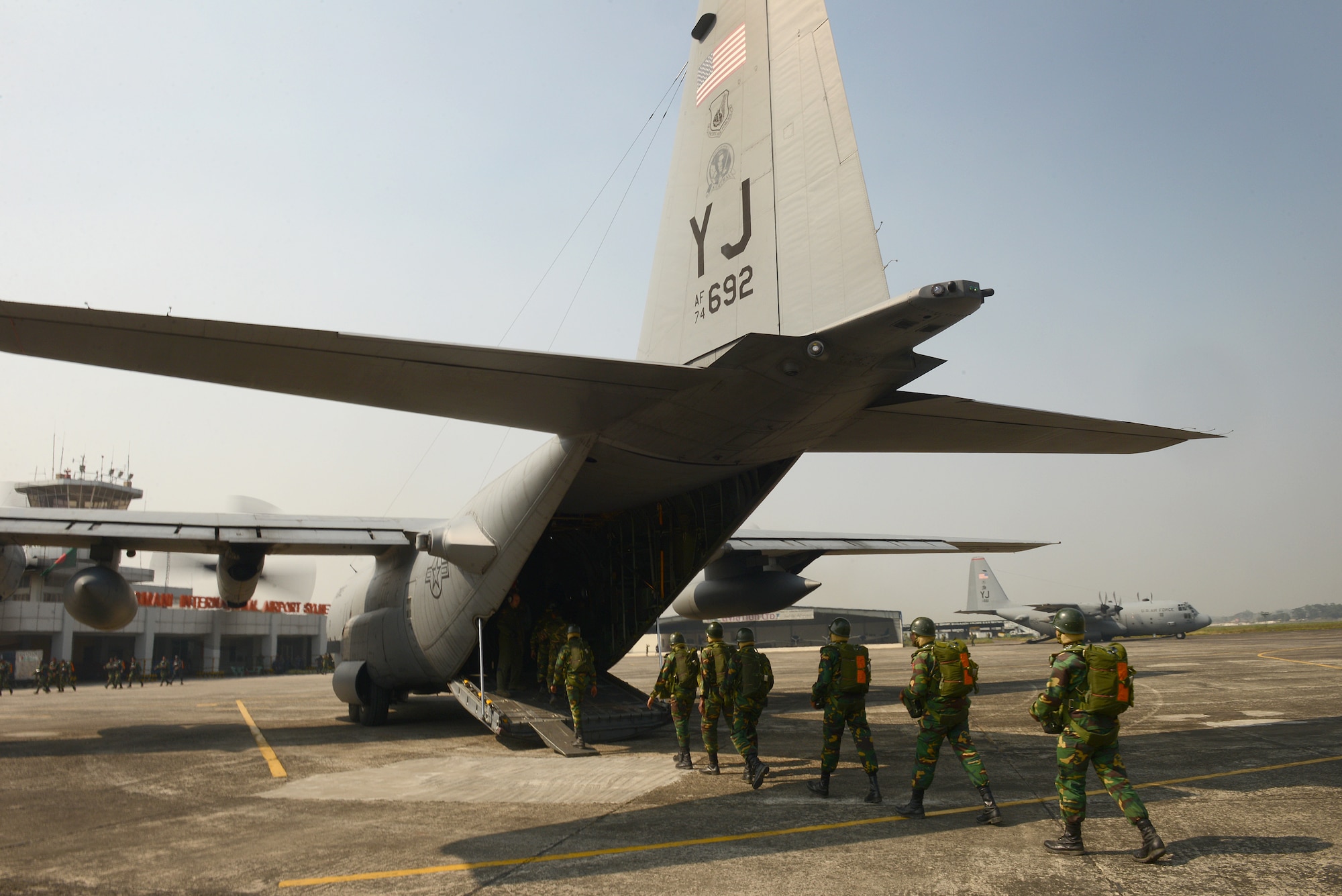 Bangladeshi commandos board a U.S. Air Force C-130H aircraft at Sylhet International Airport, Bangladesh, before conducting a personnel airdrop mission during Exercise COPE SOUTH, Jan. 25, 2015. COPE SOUTH helps cultivate common bonds, foster goodwill, and improve readiness and compatibility between members of the Bangladesh and U.S. Air Forces. (U.S. Air Force photo by 1st Lt. Jake Bailey/Released)