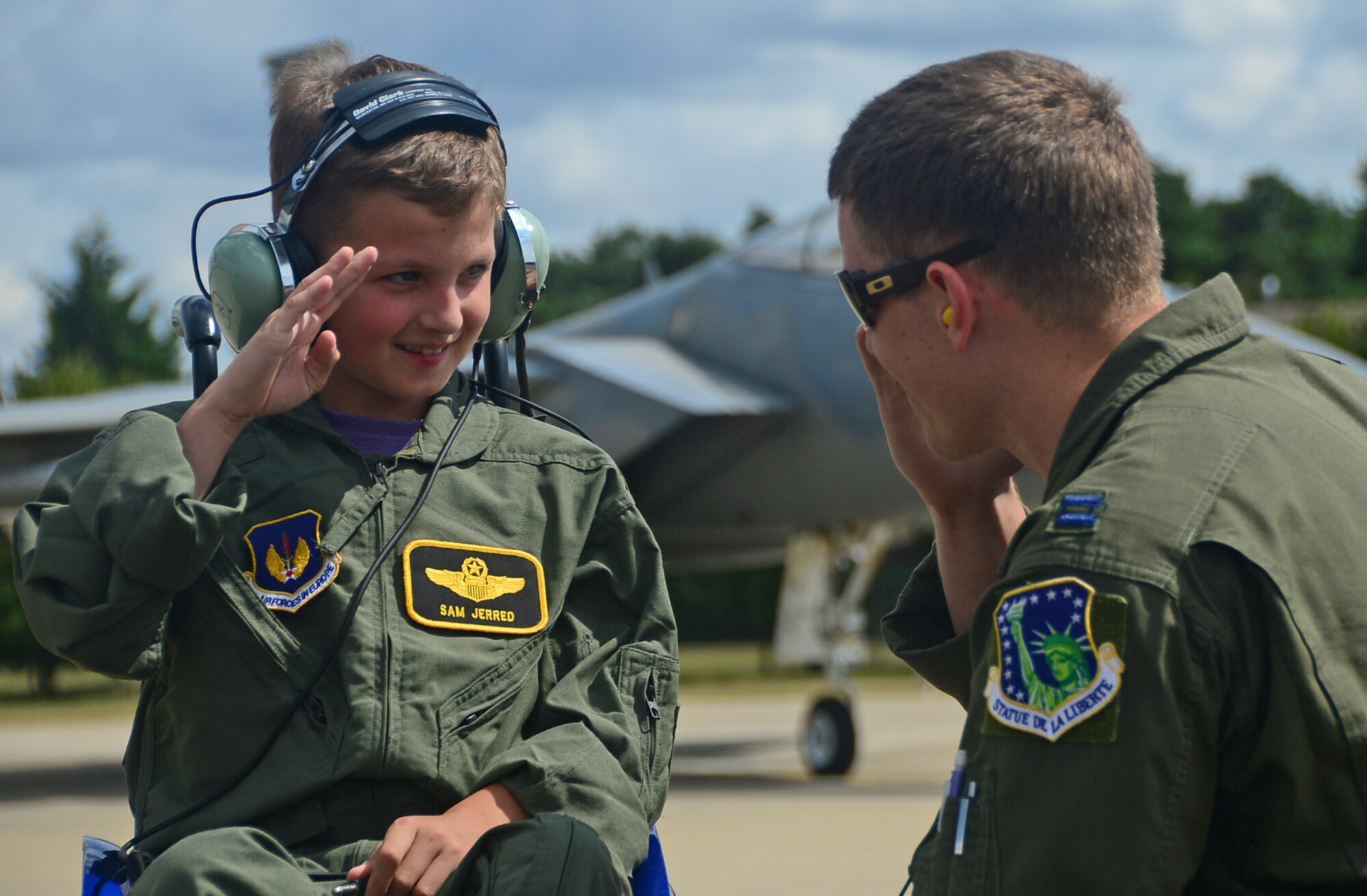 Sam Jerred, 9, salutes Capt. Matthew Tanis, 493rd Fighter Squadron F-15C Eagle pilot, after receiving honorary pilot wings on the flighline during a “Pilot for a Day” event at Royal Air Force Lakenheath, England, Aug. 4, 2014. Throughout the day, Sam was able to sit in the cockpit of an F-15E Strike Eagle, toured the air traffic control tower and watched aircraft take off from the runway. (U.S. Air Force photo by Senior Airman Erin O’Shea/Released)