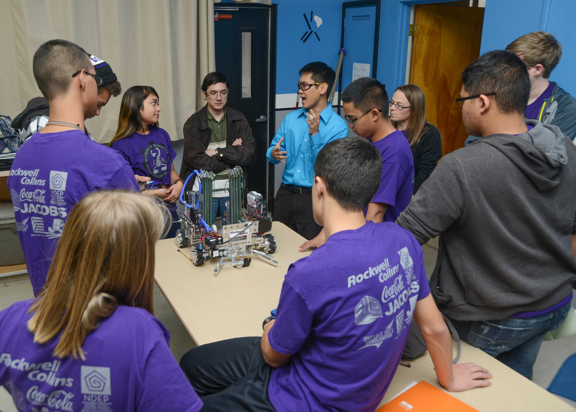 Varsity coach Andrew Whitten, 773rd Test Squadron, holds a Scorpion Robotics Team meeting at the start of each practice. After the meeting students are released to make changes or improvements to their robot. (U.S. Air Force photo by Rebecca Amber)