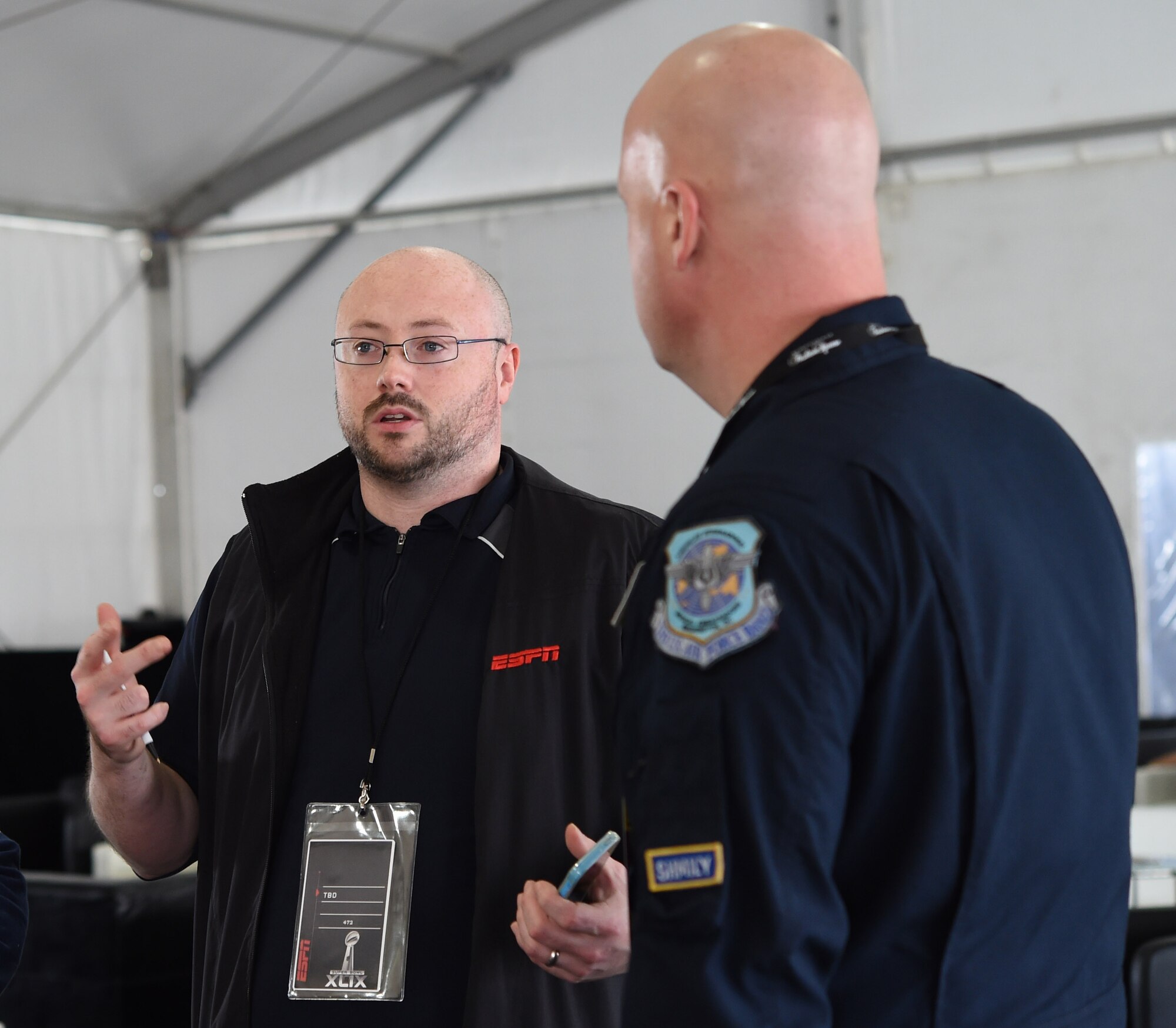Arthur Dolan, Entertainment Sports and Program Network producer, talks to Senior Master Sgt. Ryan Carson, U.S. Air Force Band Max Impact vocalist, about auditioning for a televised spot on ESPN’s Sport Center at Fan Fest in Scottsdale, Az., Jan. 27, 2015. The band’s mission is to honor those who have served, inspire American citizens to heighten patriotism and services and positively impact the global community on behalf of the USAF and United States of America.  (U.S. Air Force photo/ Senior Airman Nesha Humes)