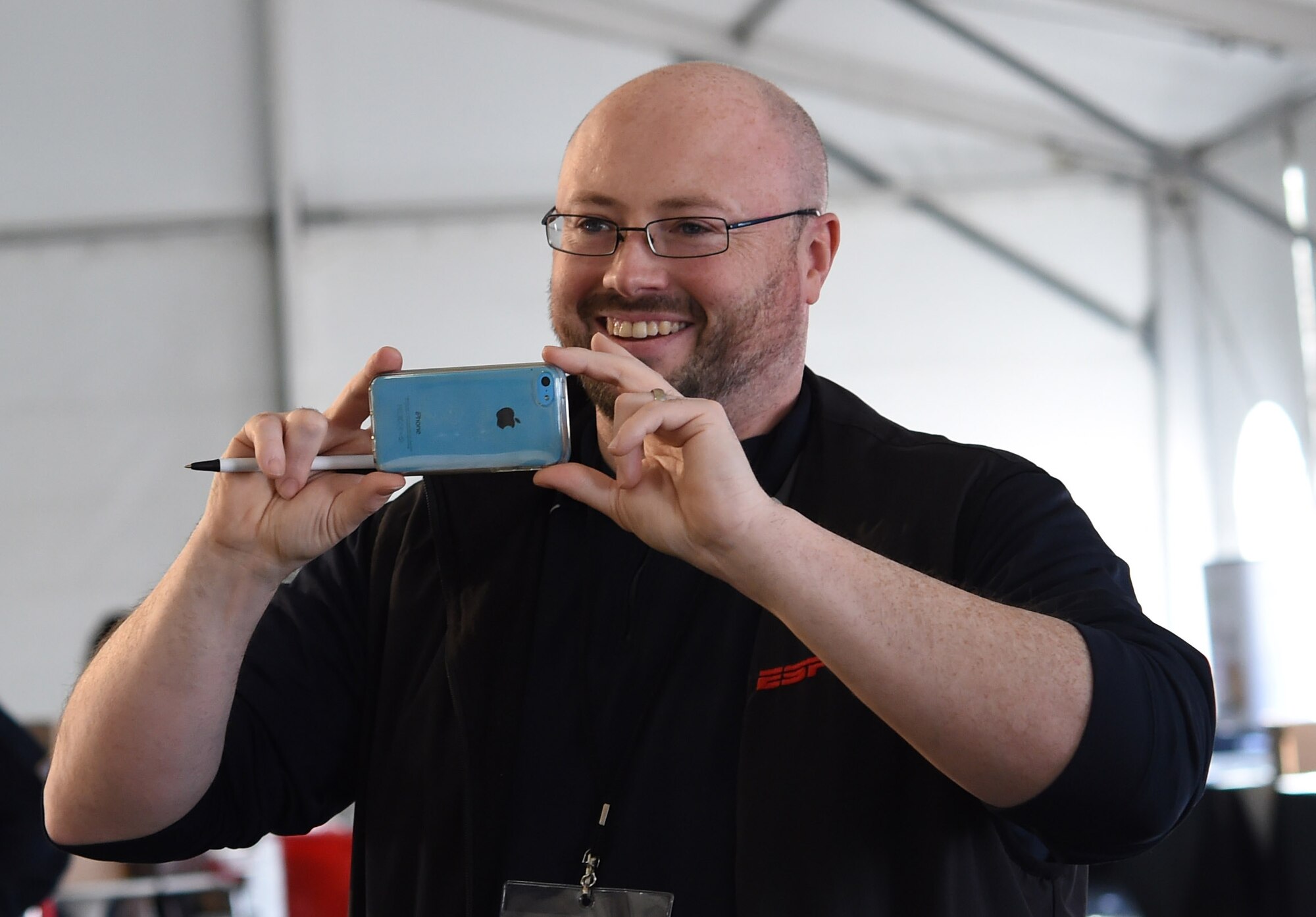 Arthur Dolan, Entertainment Sports and Program Network producer, takes a video of the U.S. Air Force premier rock band, Max Impact, during an audition for a televised spot on ESPN’s Sport Center at Fan Fest in Scottsdale, Az., Jan. 27, 2015.  The band’s mission is to honor those who have served, inspire American citizens to heighten patriotism and services and positively impact the global community on behalf of the USAF and United States of America. (U.S. Air Force photo/ Senior Airman Nesha Humes)