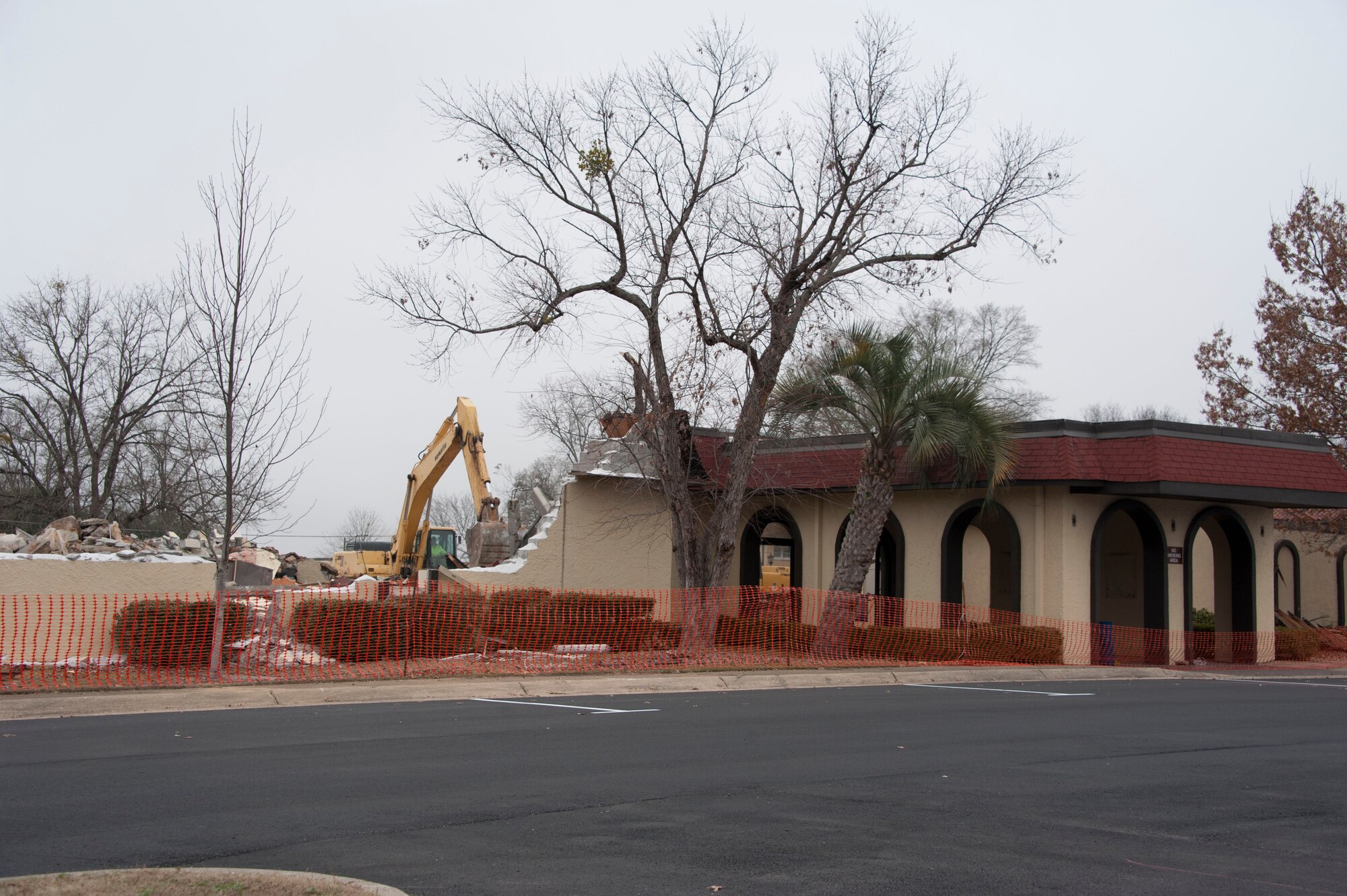 A demolition crew uses backhoes, trackhoes and dump trucks to demolish the Maxwell Event Center (MEC), building 742, here on Jan 12, 2015. Over its history building 742 has served as the Maxwell Enlisted Club and, more recently, as the Maxwell Events Center which hosted a restaurant and a barber shop. (US Air Force photo by Bud Hancock)