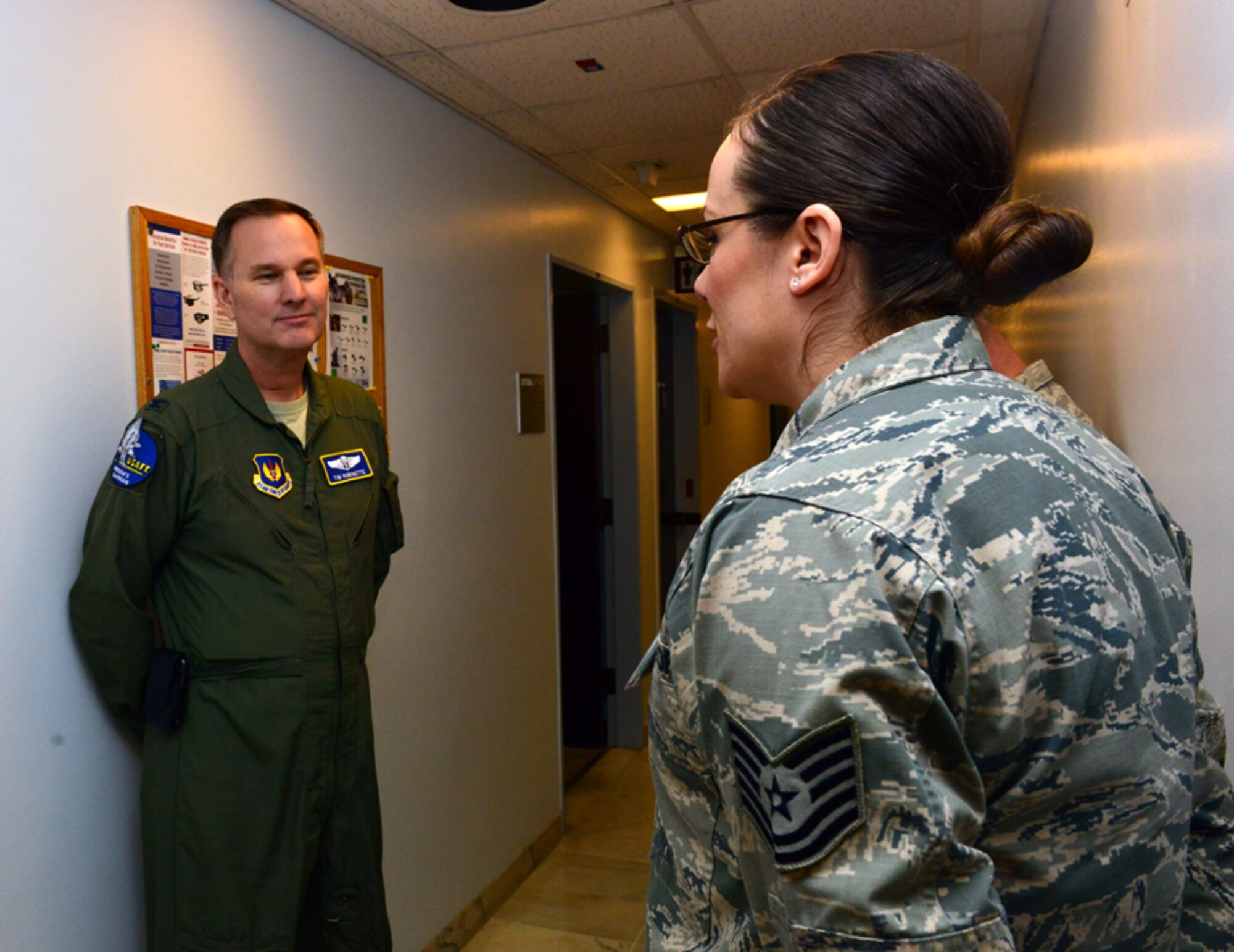 Tech. Sgt. Monica Alvarado, 39th Medical Operations Squadron optometry clinic and health and wellness center NCO in charge, briefs Col. Timothy Robinette, U. S. Air Forces in Europe and Air Forces Africa command surgeon, during a one-day 39th Medical Group visit Jan. 22, 2015, at Incirlik Air Base, Turkey. As chief flight surgeon, Robinette is board certified in aerospace medicine and occupational medicine. (U.S. Air Force photo by Senior Airman Michael Battles/Released)