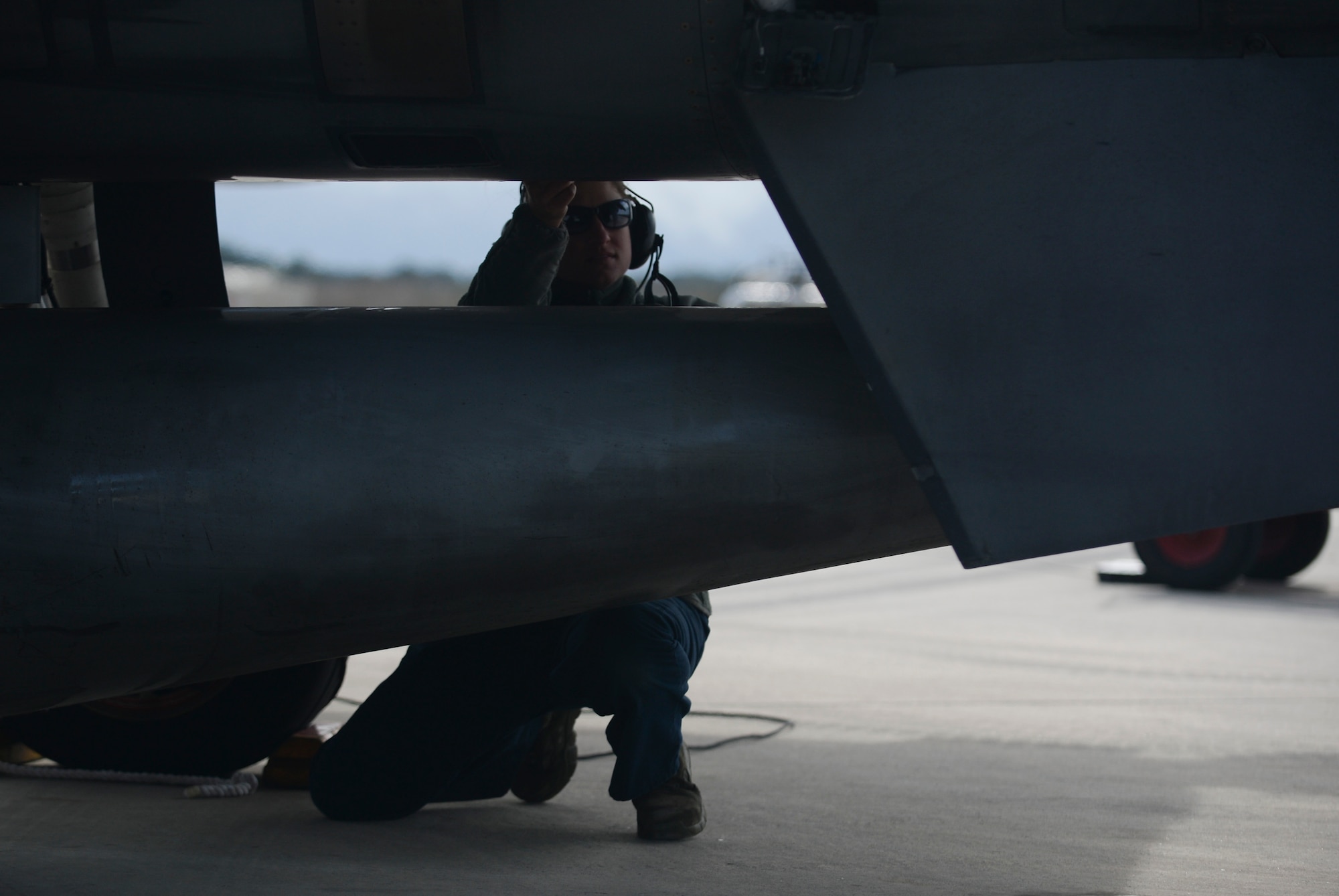 U.S. Air Force Senior Airman Juli Sweger, a dedicated crew chief assigned to the 52nd Expeditionary Aircraft Maintenance Squadron inspects the fuel cell below an F-16 Fighting Falcon fighter aircraft during a flying training deployment on the flightline at Souda Bay, Greece, Jan. 27, 2015.Sweger performed the secondary check before the aircraft taxied on the runway for takeoff. (U.S. Air Force photo by Staff Sgt. Joe W. McFadden/Released)