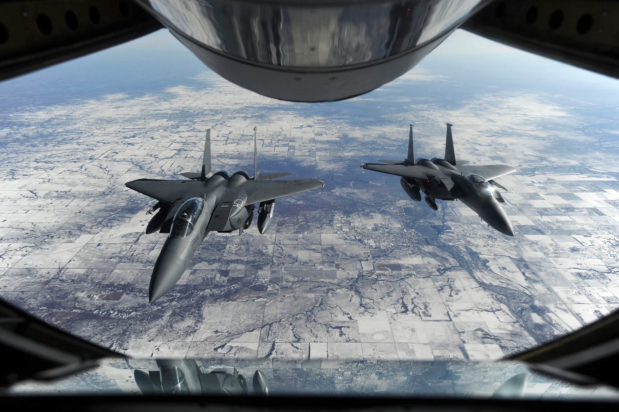 Two F-15E Strike Eagles assigned to the 4th Fighter Wing on their way to Nellis Air Force Base, Nevada, in support of Red Flag 15-1, wait to receive fuel from a KC-135R Stratotanker assigned to the 916th Air Refueling Wing on Jan. 23, 2015. Red Flag 15-1, featuring aircraft from 21 different U.S. Air Force squadrons, offers realistic combat training involving the air, space and cyber forces of the United States and its allies. (U.S. Air Force photo/Airman 1st Class Aaron J. Jenne)