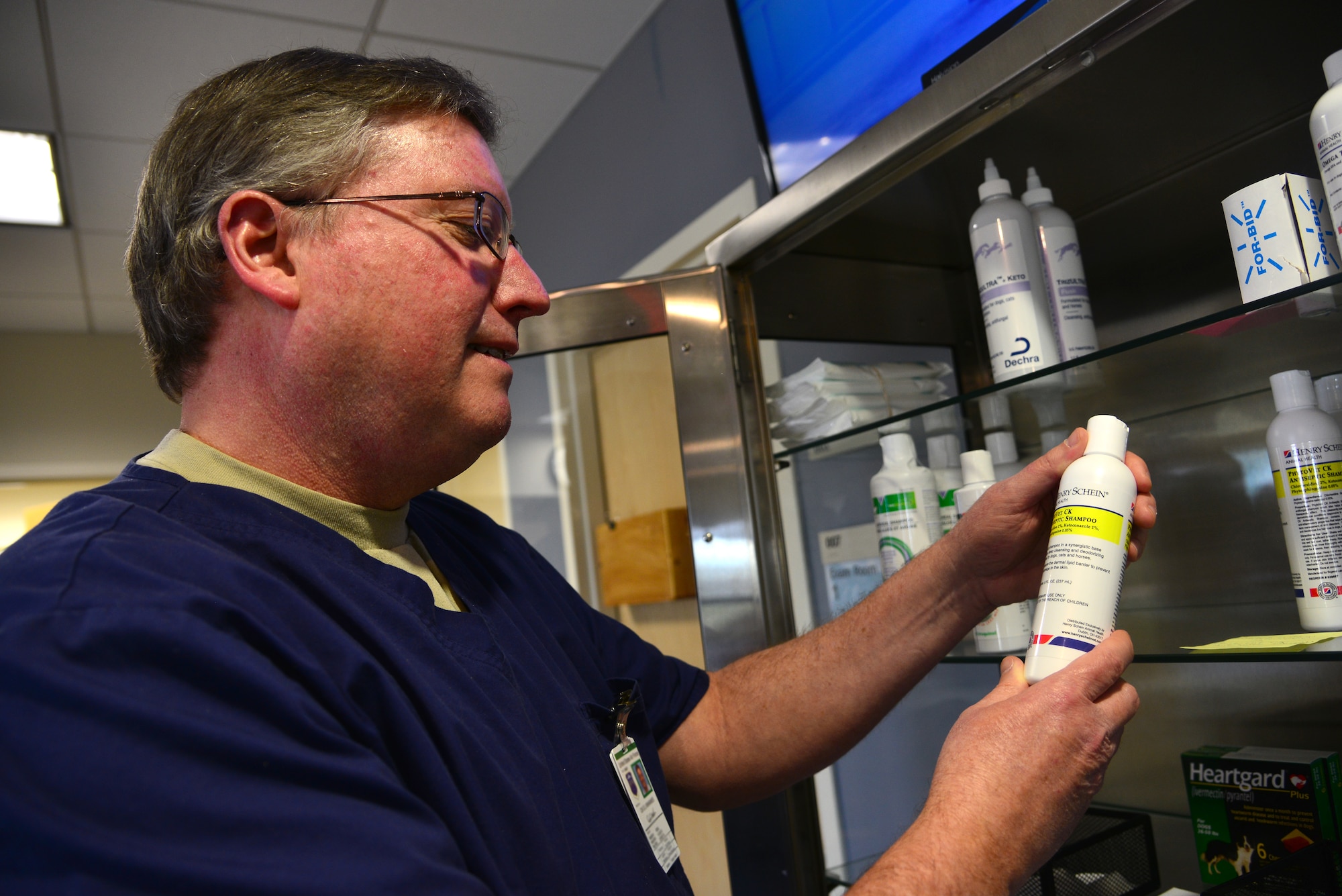 Dave Mahanes, 633rd Medical Support Squadron Veterinary Treatment Facility operations assistant, reviews pet shampoo stock at Langley Air Force Base, Va., Jan. 27, 2015. Toiletries, including and heartworm, flea and tick medication, are available for purchase during business hours. (U.S. Air Force photo by Senior Airman Aubrey White/Released)