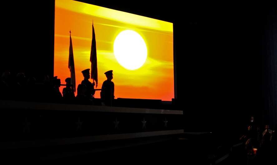 From right, U.S. Army Sgt. Jacob A. King, Sgt. Marc D. Troxel, U.S. Air Force Chief Master Sgt. Diana L. Braun and Master Sgt. Jennifer E. Weitekamp, all Illinois National Guard color guard members, prepare to present the colors as a video of Illinois' history plays at the inauguration ceremony of Governor-elect Bruce Rauner in Springfield, Ill., Jan. 12, 2015. As Illinois' governor, Rauner will serve as the commander in chief for the Soldiers and Airmen of the Illinois National Guard while they are not under federal activation. (U.S. Air National Guard photo by Staff Sgt. Lealan Buehrer/Released)