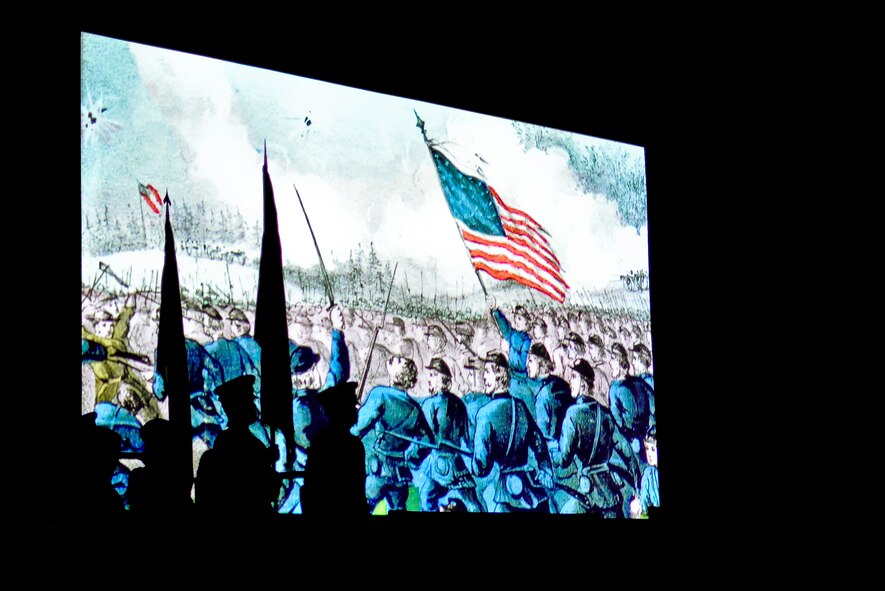 From right, U.S. Army Sgt. Jacob A. King, Sgt. Marc D. Troxel, U.S. Air Force Chief Master Sgt. Diana L. Braun and Master Sgt. Jennifer E. Weitekamp, all Illinois National Guard color guard members, prepare to present the colors as a video of Illinois' history plays at the inauguration ceremony of Governor-elect Bruce Rauner in Springfield, Ill., Jan. 12, 2015. As Illinois' governor, Rauner will serve as the commander in chief for the Soldiers and Airmen of the Illinois National Guard while they are not under federal activation. (U.S. Air National Guard photo by Staff Sgt. Lealan Buehrer/Released)