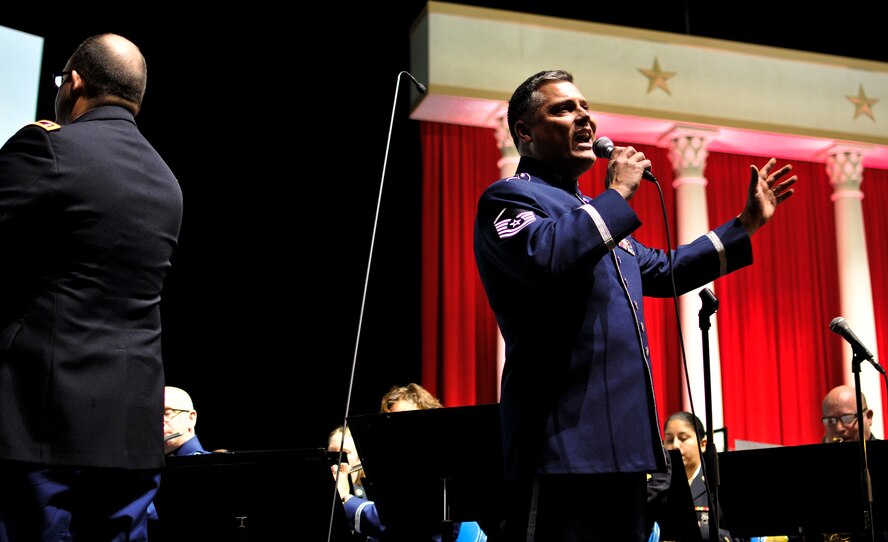 U.S. Air Force Master Sgt. Douglas A. Mattsey, regional band craftsman with the 566th Air Force Band, sings with the Illinois National Guard's 144th Army Band and 566th Air Force Band as they perform at the inauguration ceremony of Governor-elect Bruce Rauner in Springfield, Ill., Jan. 12, 2015. As Illinois' governor, Rauner will serve as the commander in chief for the Soldiers and Airmen of the Illinois National Guard while they are not under federal activation. (U.S. Air National Guard photo by Staff Sgt. Lealan Buehrer/Released)