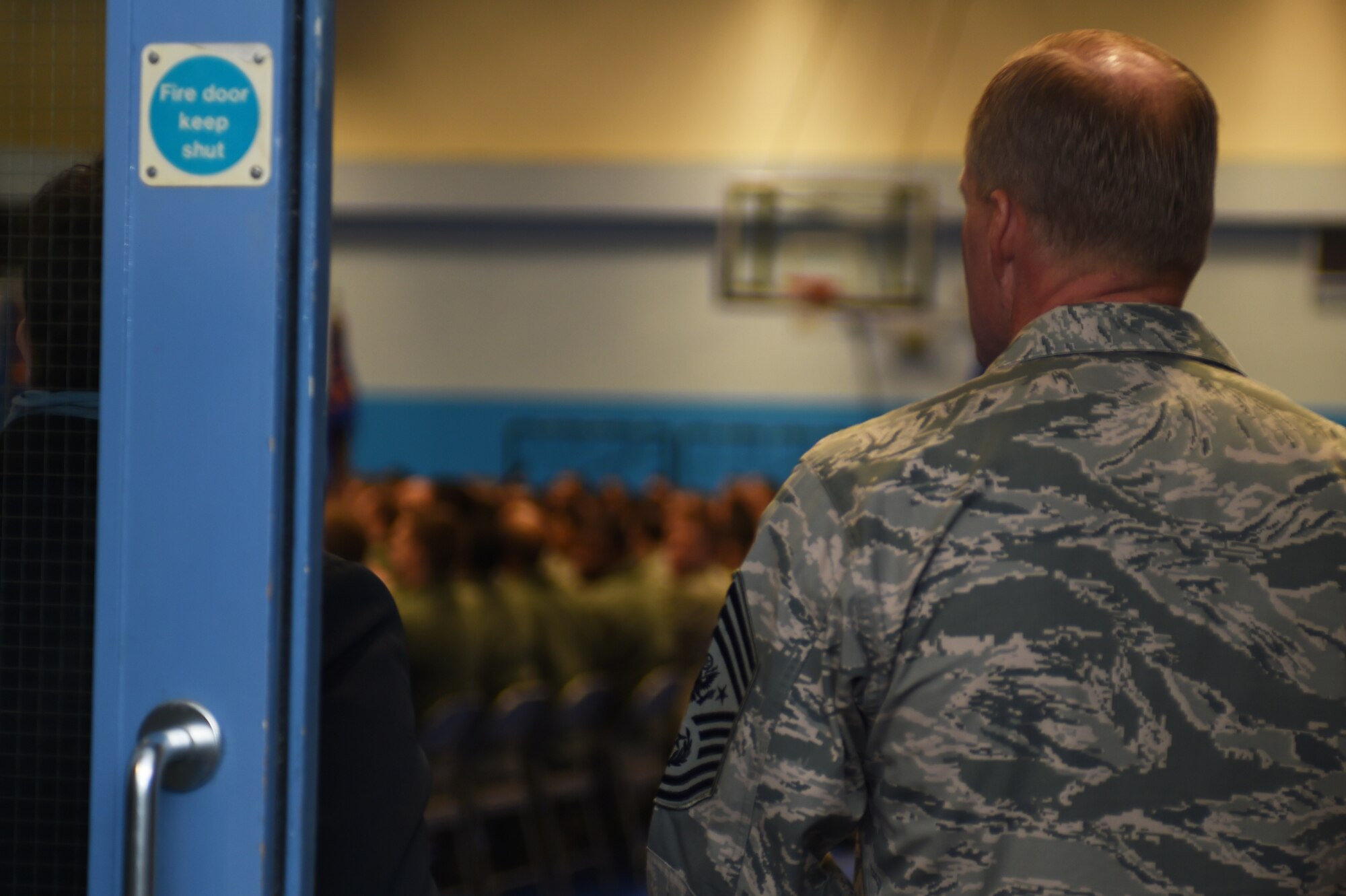 Chief Master Sgt. of the Air Force James A. Cody enters the gymnasium at RAF Croughton, England, prior to holding an all-call with Airmen, Jan. 28, 2015. Cody spoke on several topics pertaining to the U.S. Air Force, before taking questions from Airmen. (U.S. Air Force photo by Staff Sgt. Jarad A. Denton/Released)