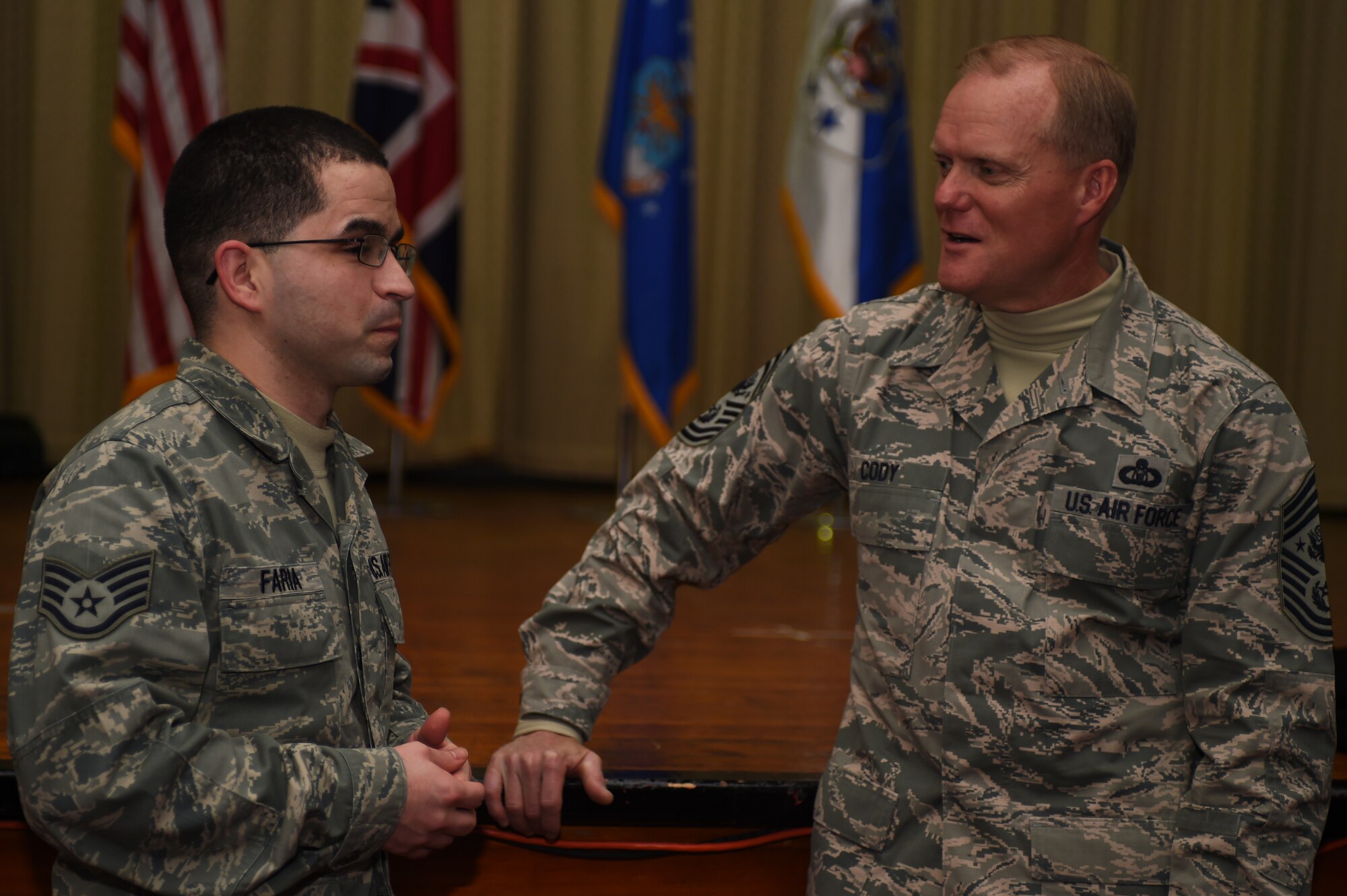 Staff Sgt. Richard Faria Jr., from the 421st Air Base Squadron, left, speaks with Chief Master Sgt. of the Air Force James A. Cody after an all-call at RAF Alconbury, England, Jan. 27, 2015. Cody spoke with Airmen regarding the current state and potential future direction of the U.S. Air Force. (U.S. Air Force photo by Staff Sgt. Jarad A. Denton/Released)