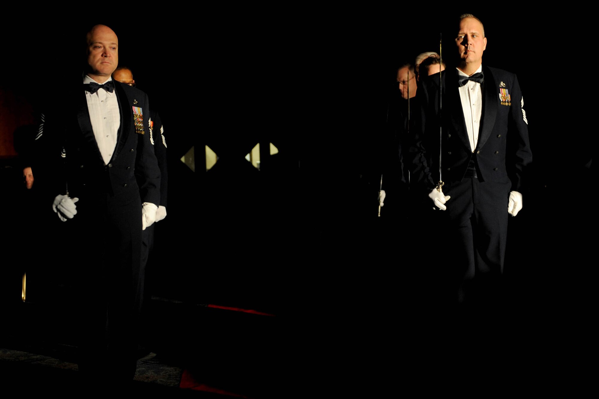 U.S. Air Force chief master sergeants set up a saber cordon during the Chief Master Sergeant Recognition Ceremony in Club Eifel at Spangdahlem Air Base, Germany, Jan. 23, 2015. The chief master sergeants volunteered to welcome the new chief selects into their ranks. (U.S. Air Force photo by Airman 1st Class Timothy Kim/Released)
