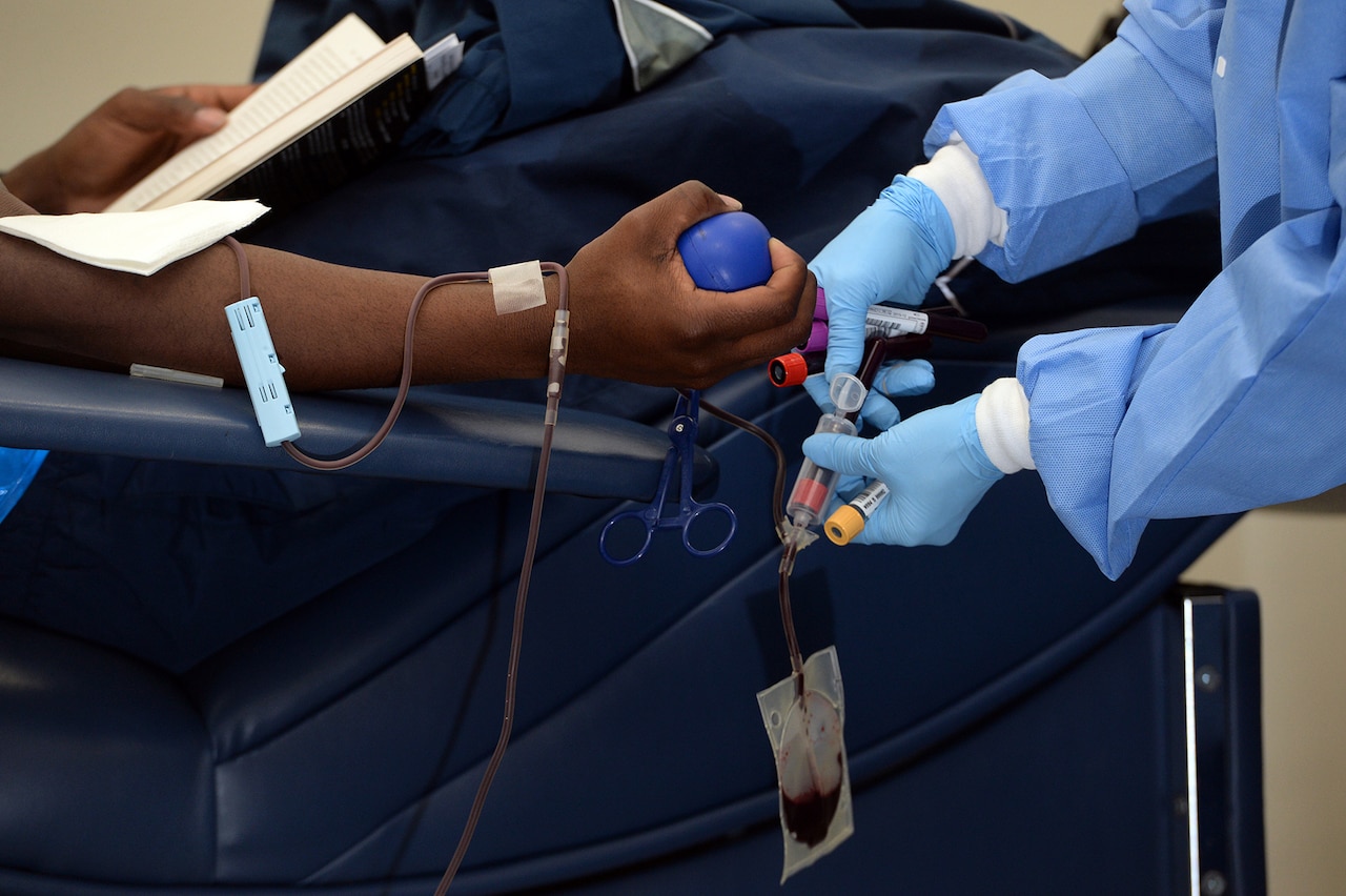 A phlebotomist draws blood from a donor at the Akeroyd Blood Donor Center at Joint Base San Antonio, Texas, Dec. 12, 2014. The blood donor center is part of the Armed Services Blood Program, the official U.S. military blood program. For more than 60 years, the ASBP has been collecting, processing and distributing blood products for the military community. DoD photo by EJ Hersom